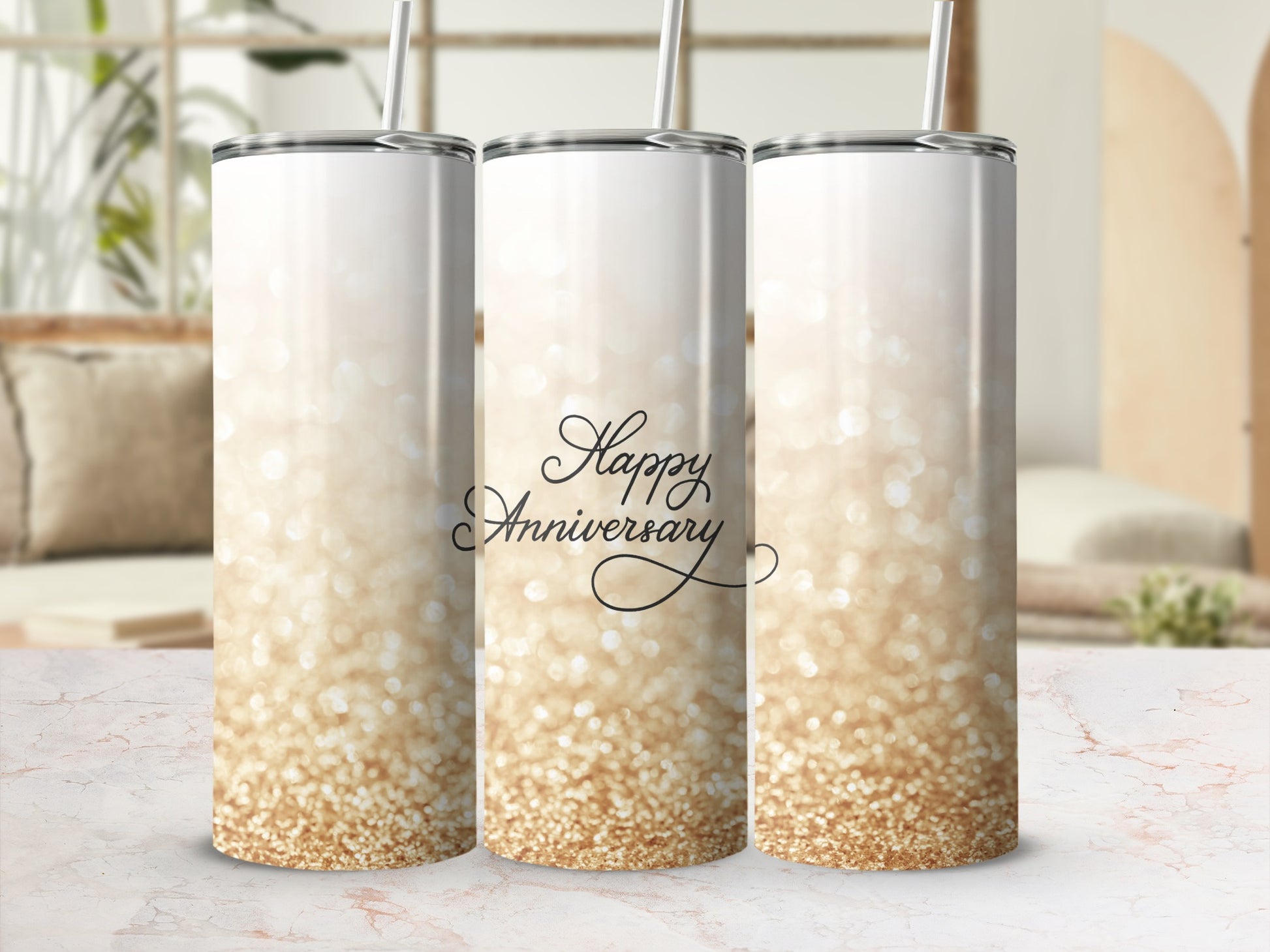 Glittering "Happy Anniversary" text on a tall, slender white tumbler with a straw.