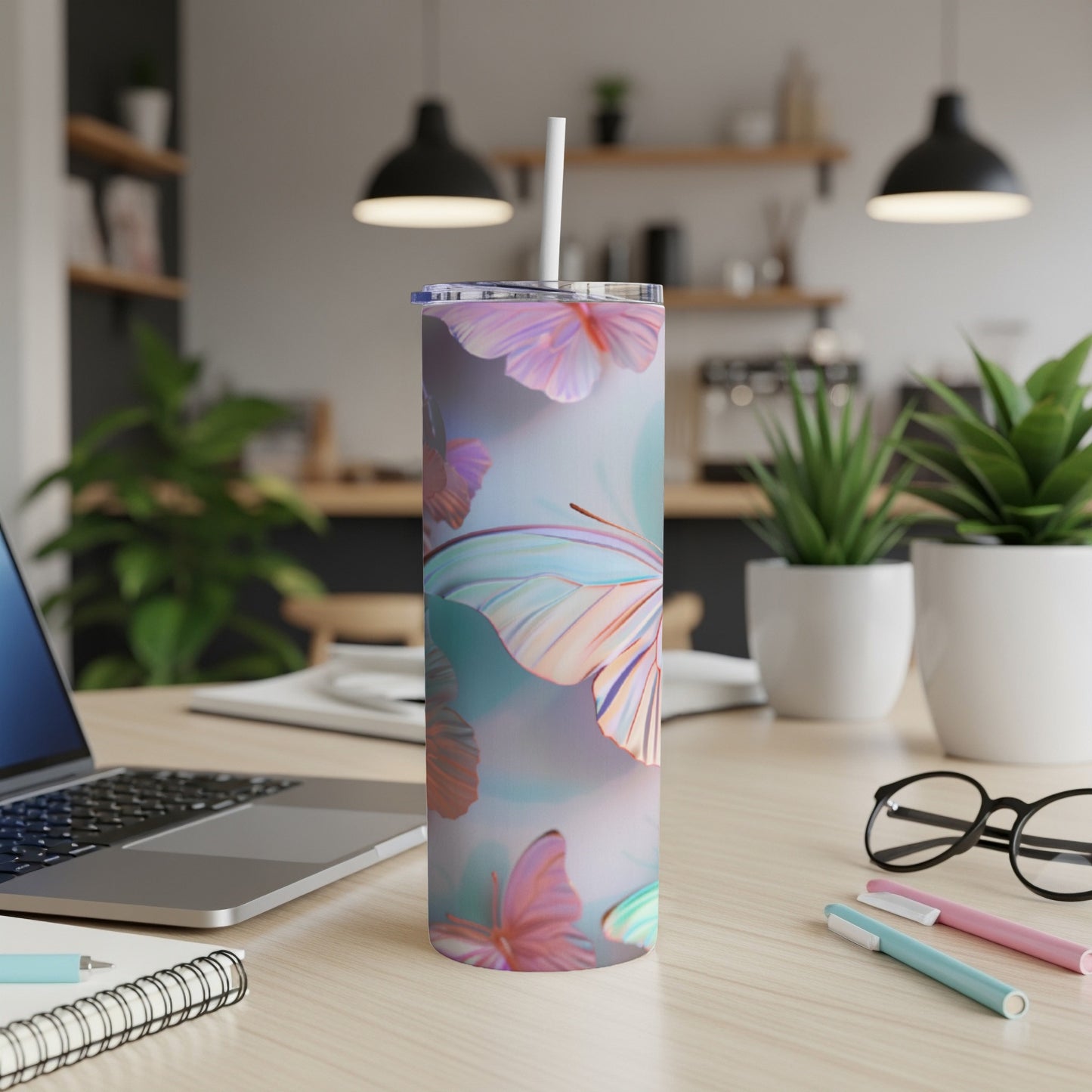 Pink and blue butterfly pattern on a white insulated tumbler with straw.