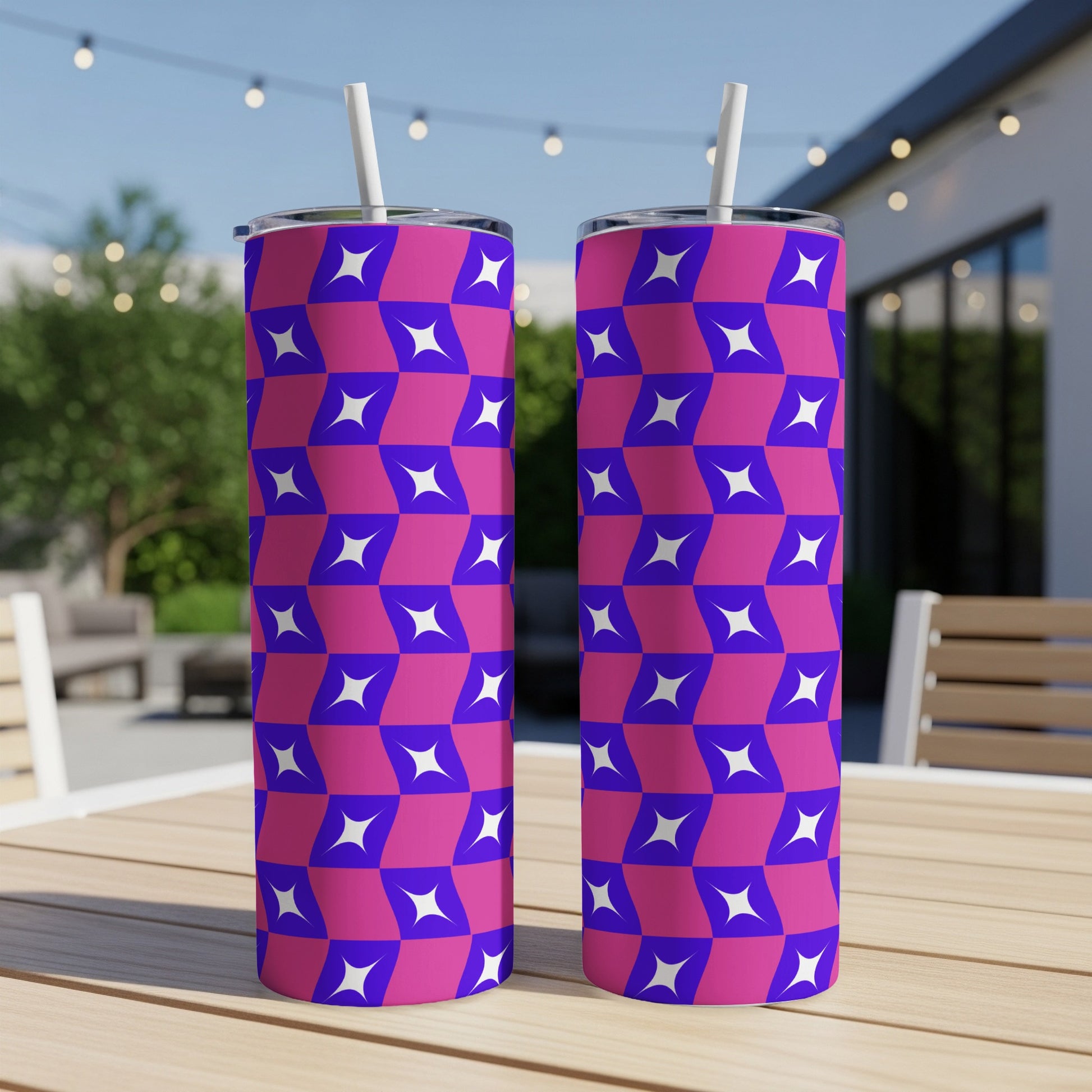 Two tall tumblers with a purple and white geometric star pattern and straws.