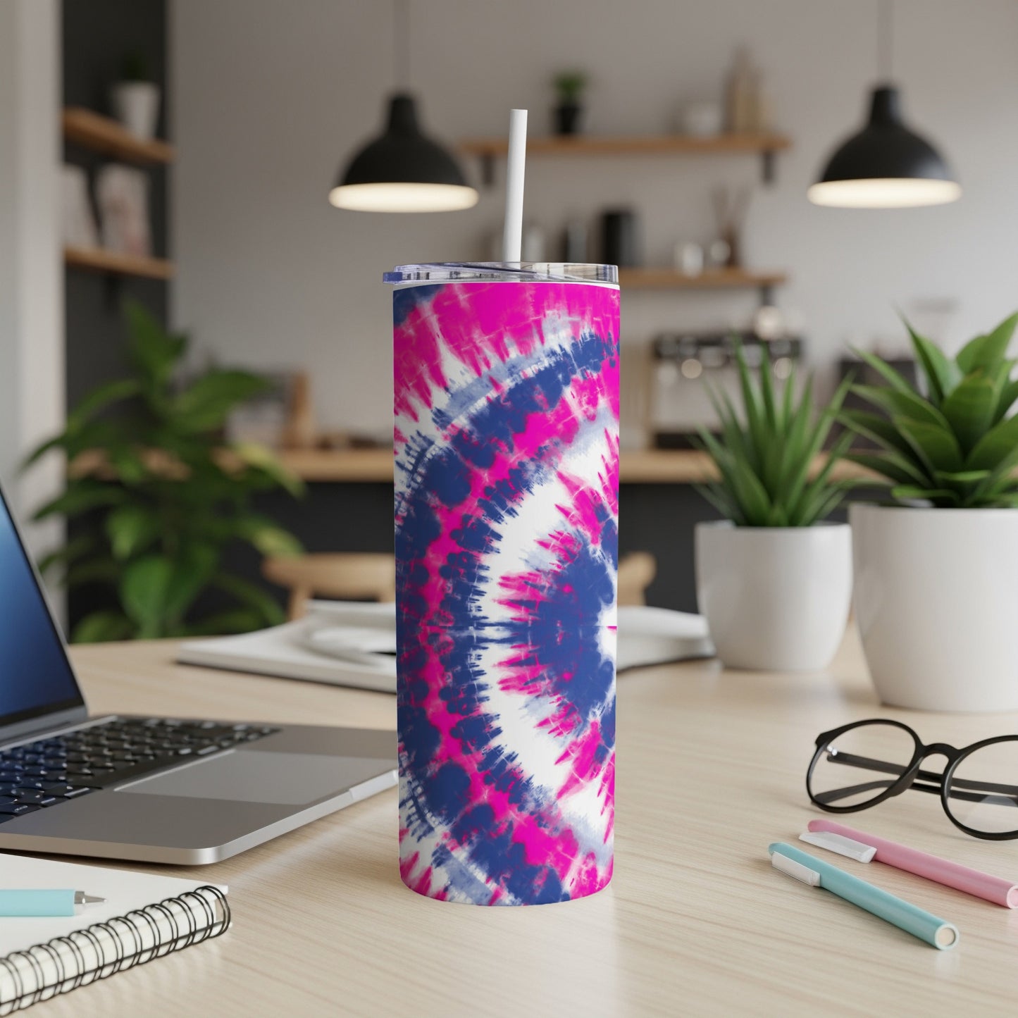 Tumbler with pink and blue tie-dye pattern and straw.