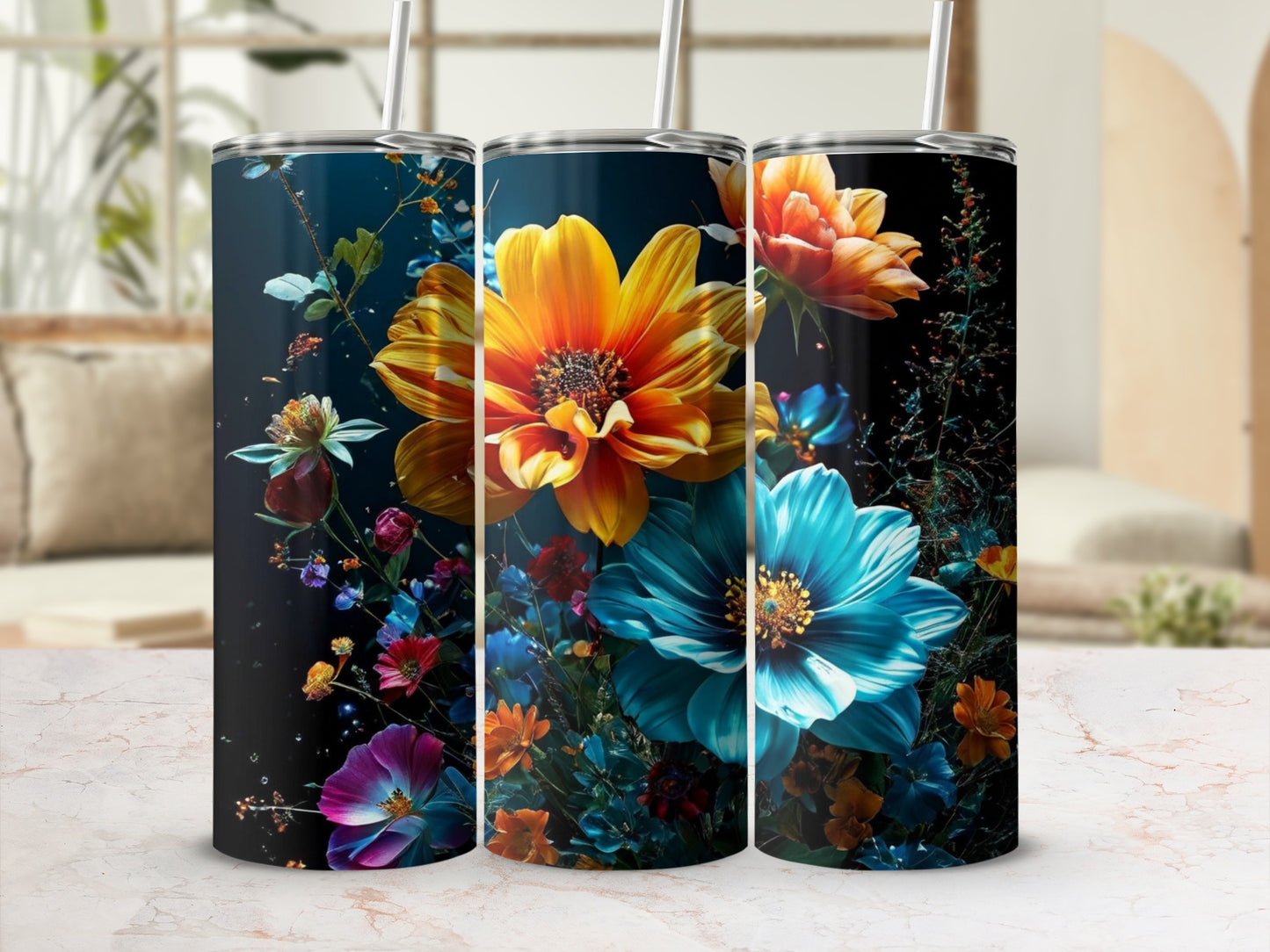 Three tall tumblers with vibrant floral designs on a marble surface.