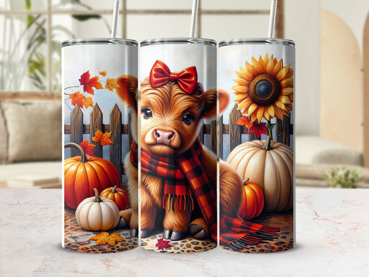 Cow wearing scarf and bow, with pumpkins and sunflower, on tumbler.