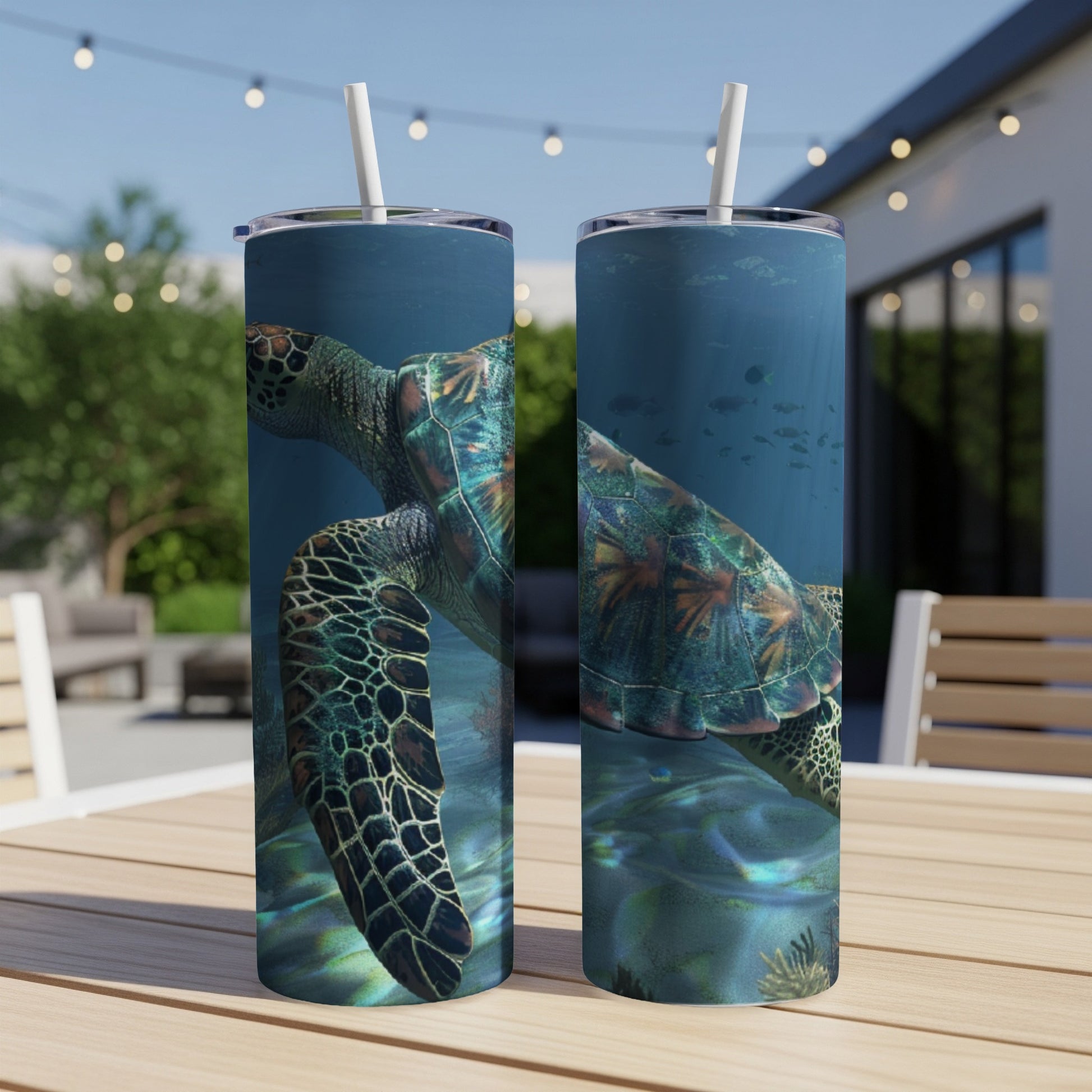Two tumblers with a sea turtle design sit on a table.