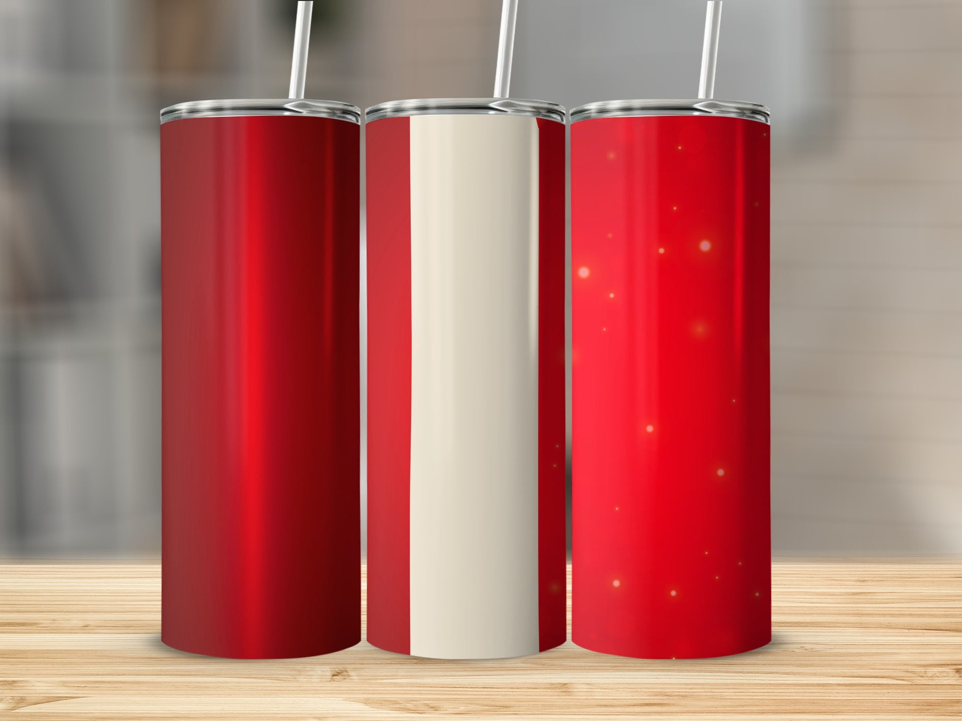 Three red tumblers with white stripe and gold sparkles on wood.