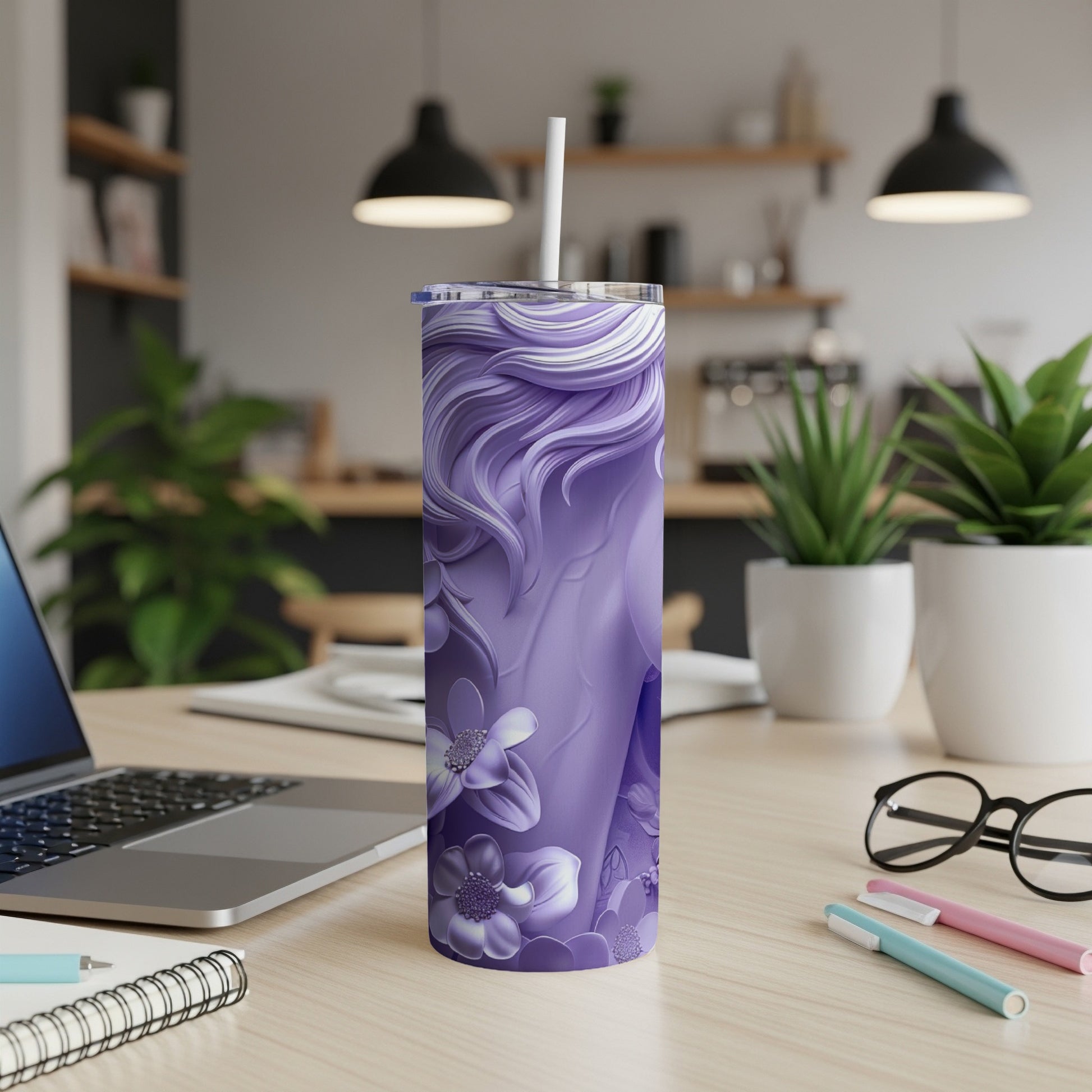 Purple floral tumbler with straw on a desk.