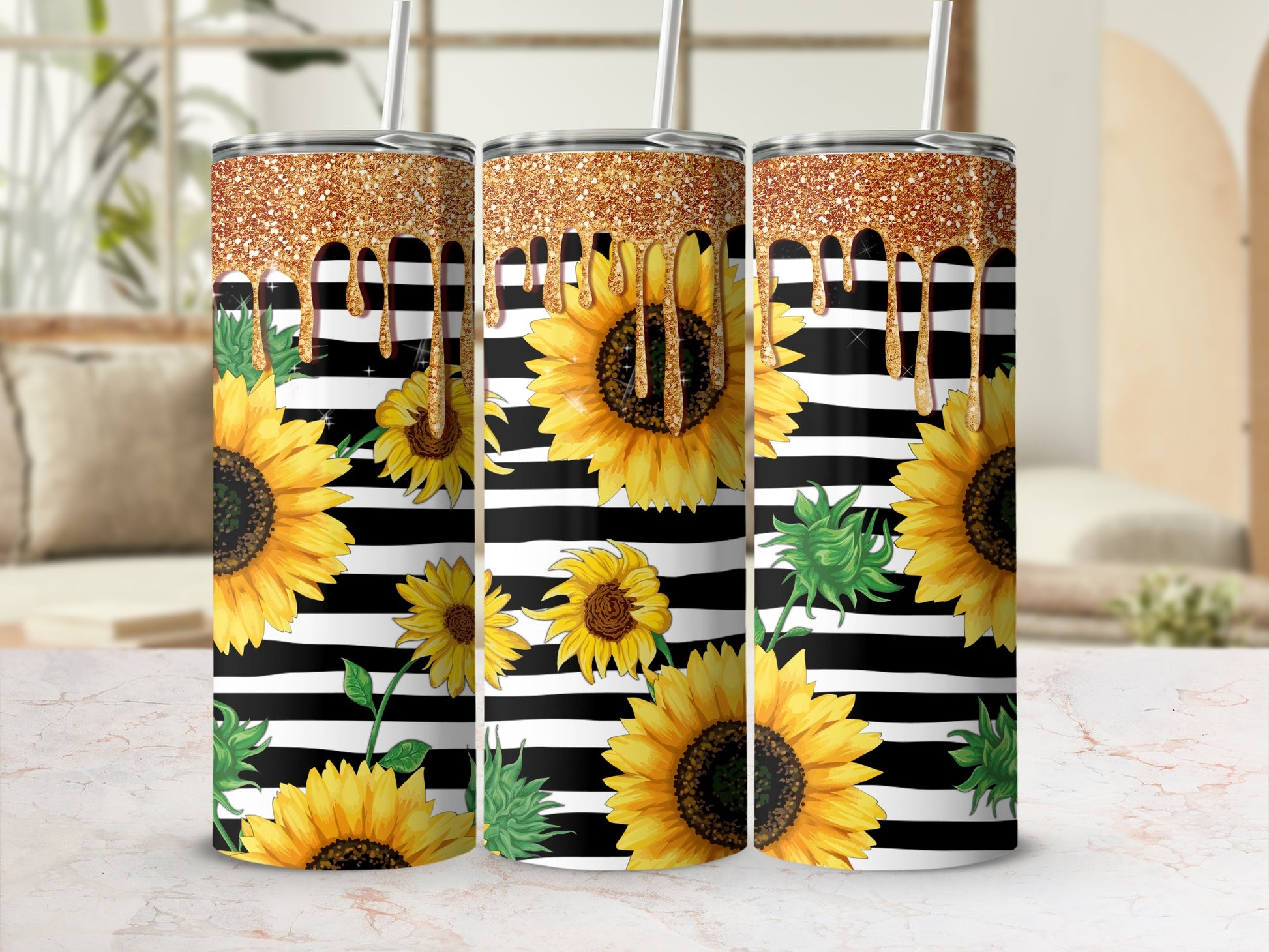 Three sunflowers with glitter drips on a striped tumbler.