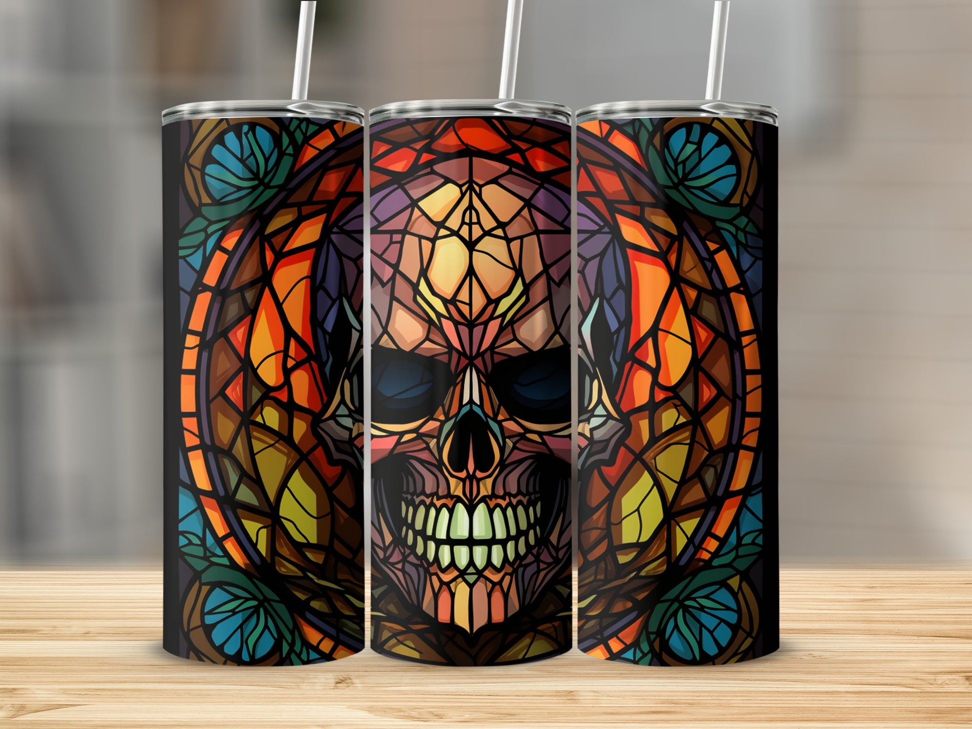 Stained glass skull design on three black skinny tumblers.