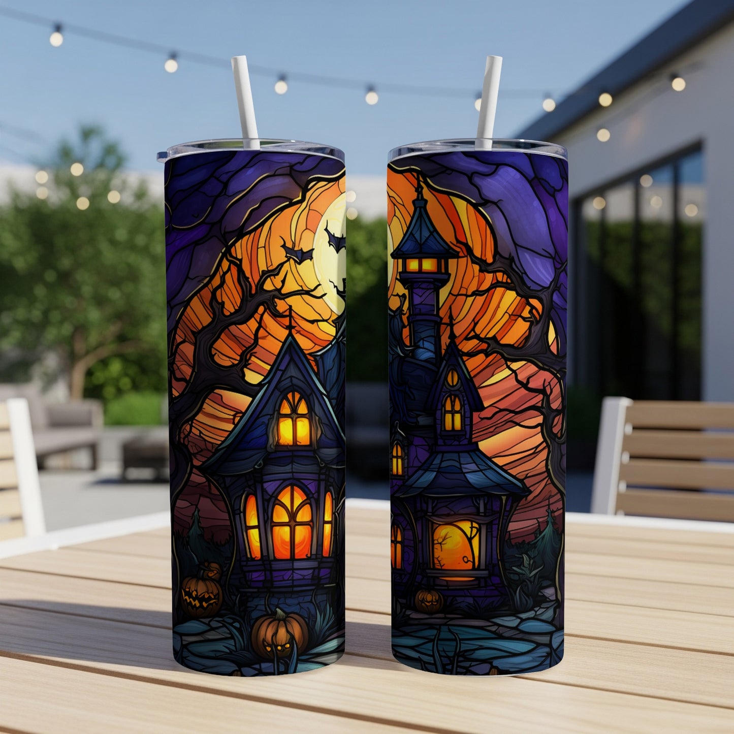Two tumblers with a spooky Halloween house, moon, and pumpkins.