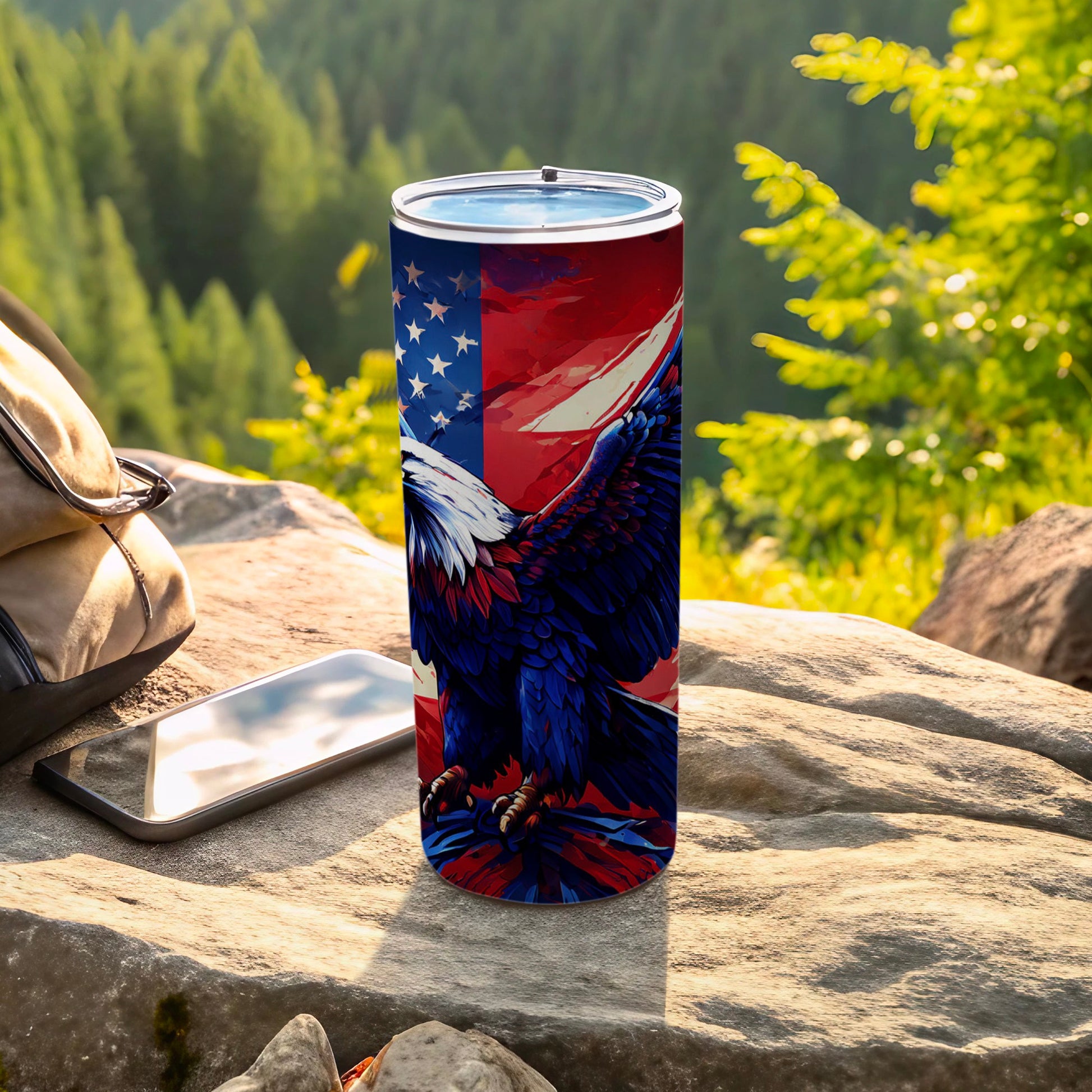 Patriotic eagle design tumbler with American flag on a rock.
