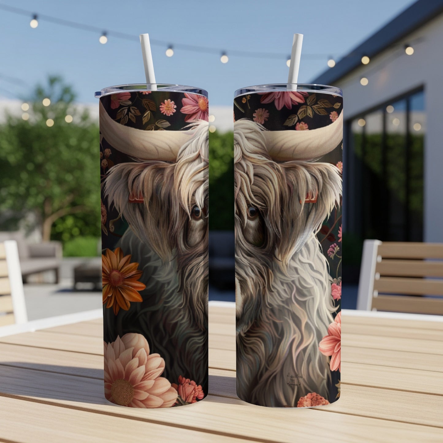 Highland cow with floral accents on a patterned tumbler.