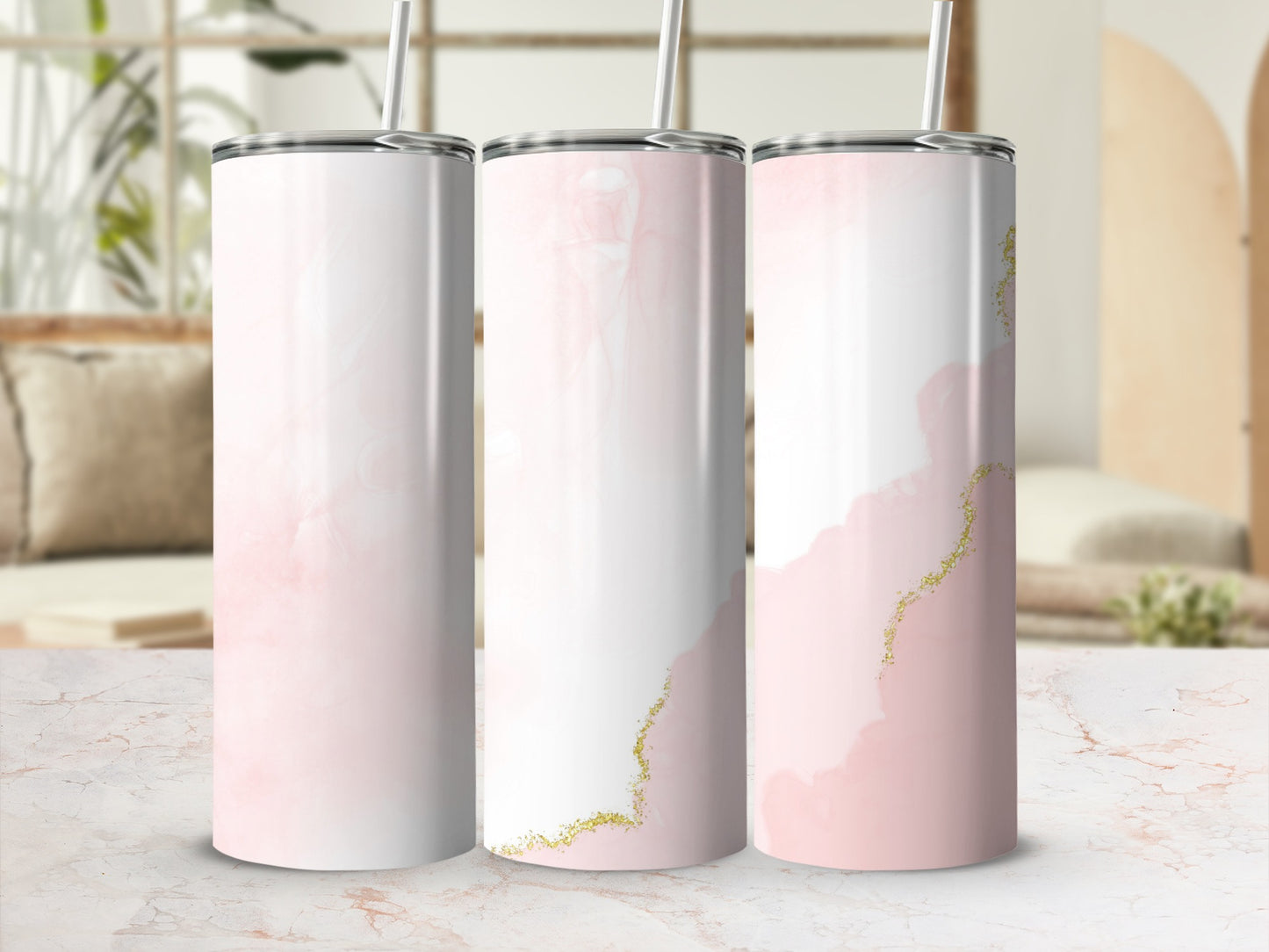 Three pastel pink and white tumblers with gold glitter accents.