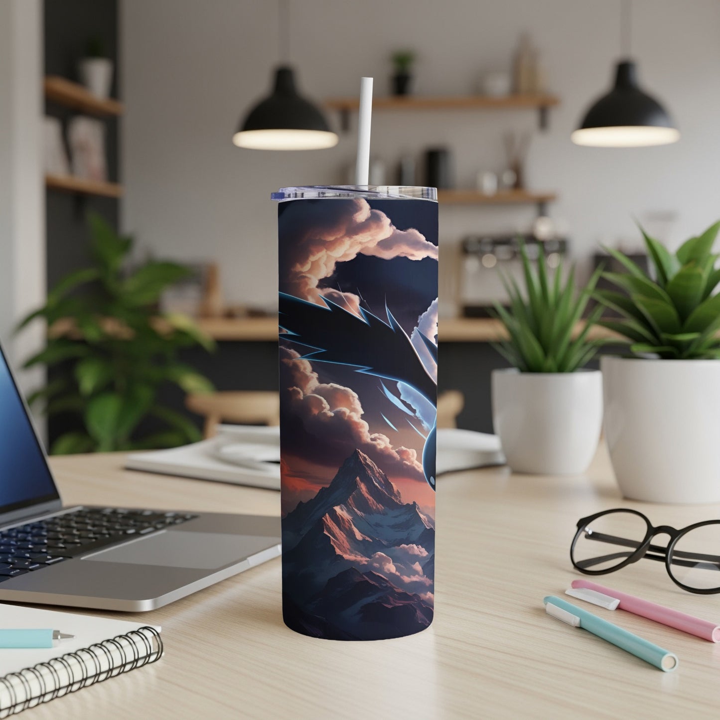 Dragon design on a dark insulated tumbler with mountains and clouds.