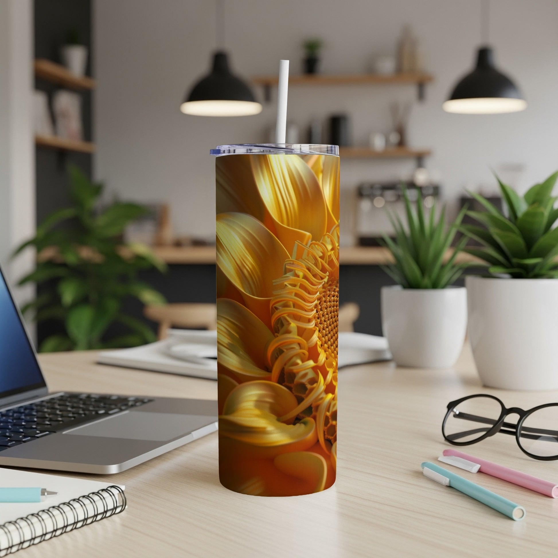 Sunflower tumbler with straw on desk.