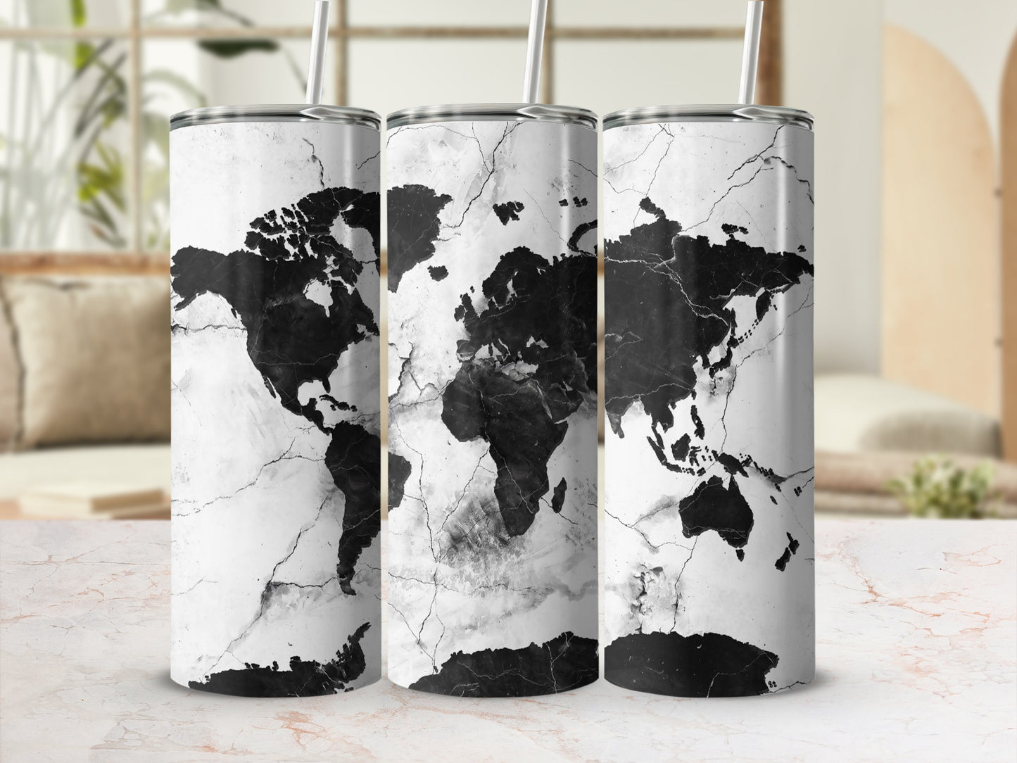 Three tumblers with a black world map design on white marble background.