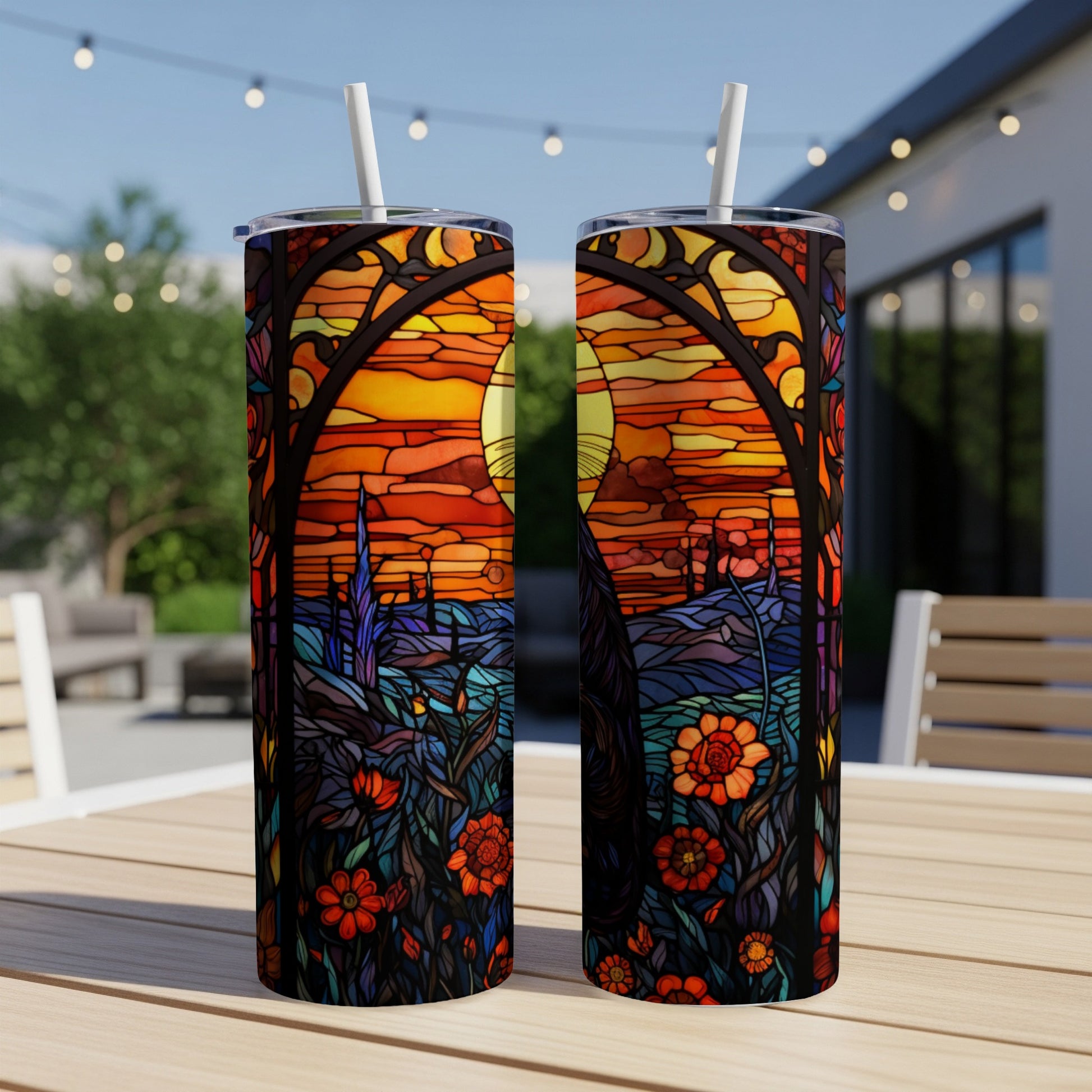 Two tumblers with a stained glass sunset and floral design.