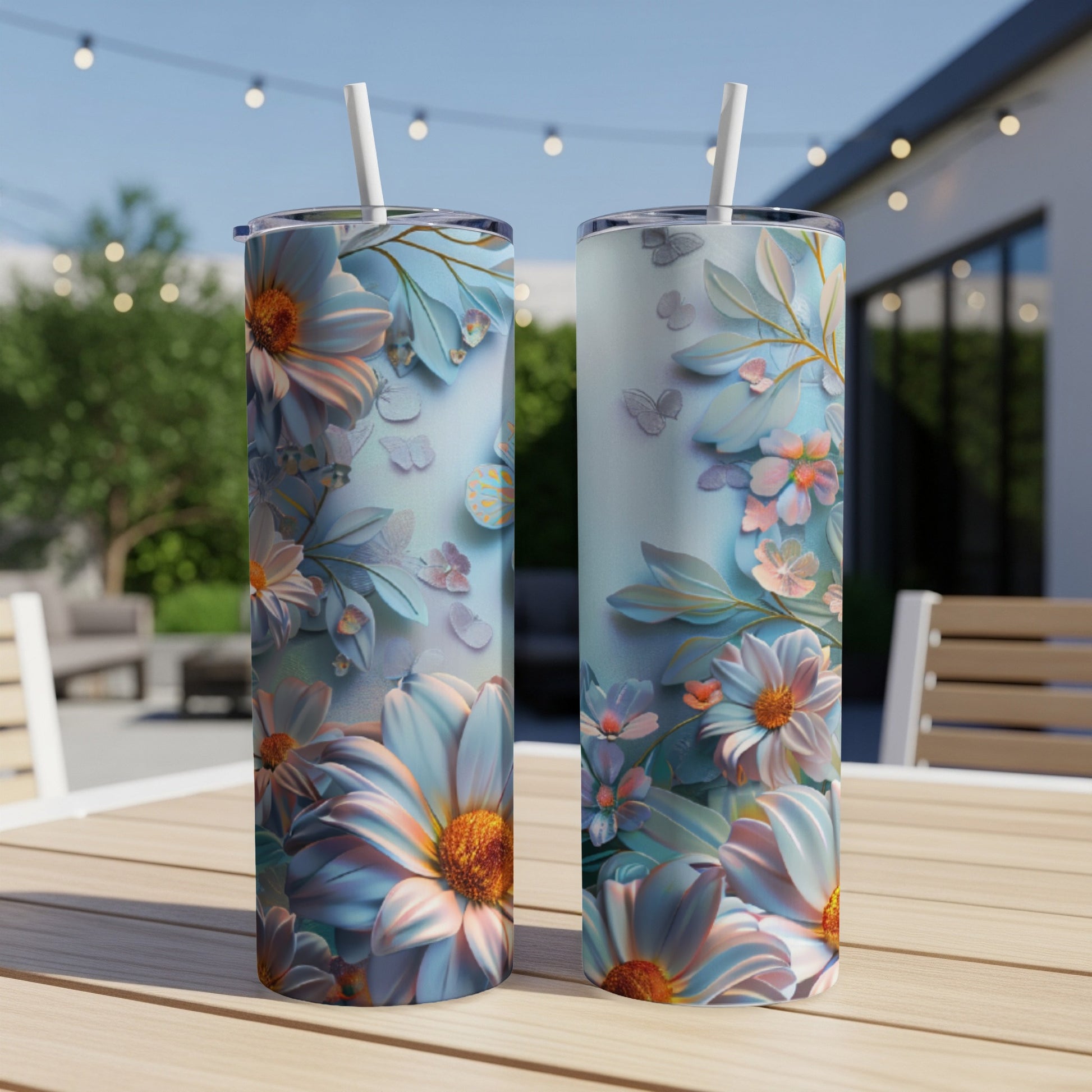 Two tall, slender tumblers with a light blue floral and butterfly design.