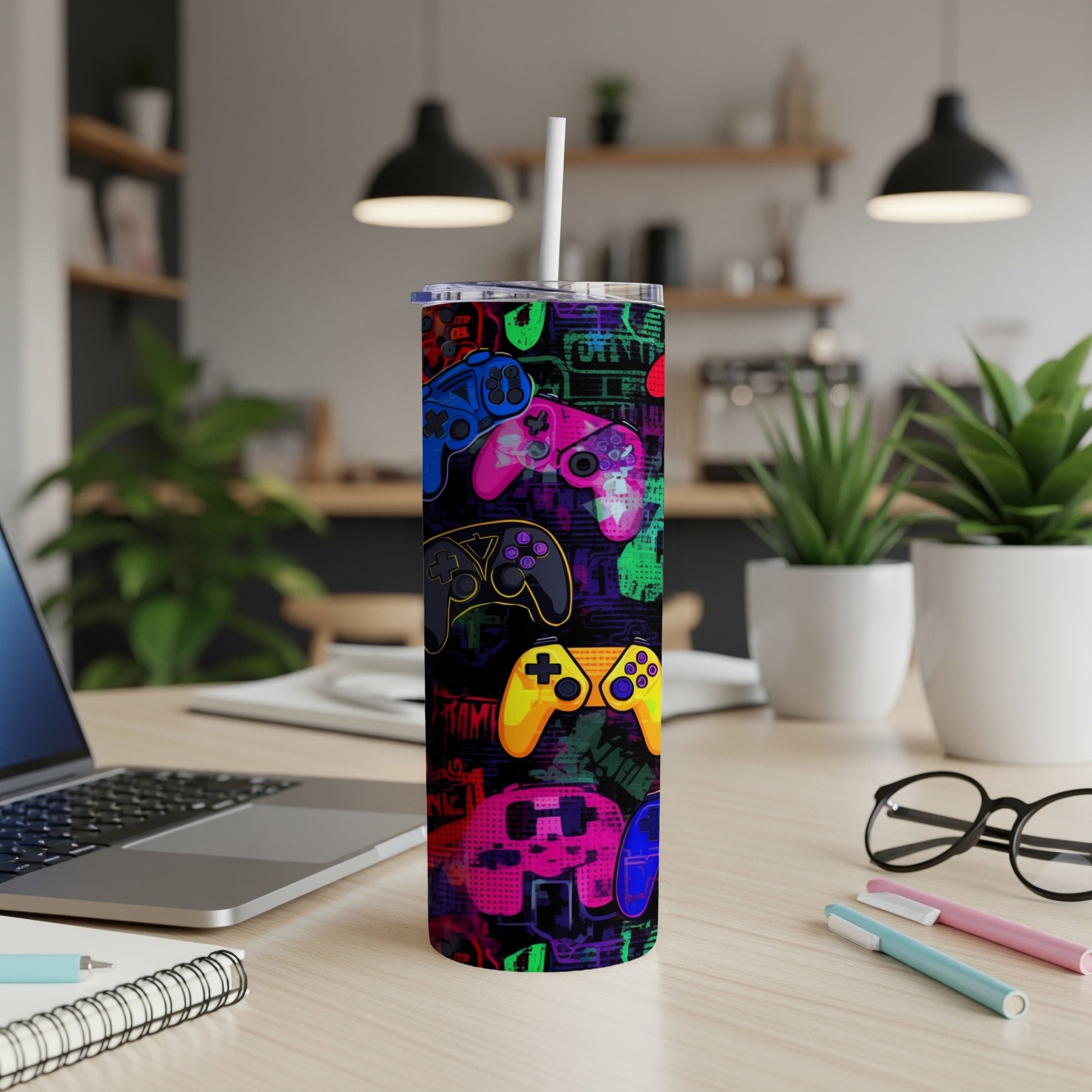 Colorful video game controllers pattern on a white tumbler with a straw.
