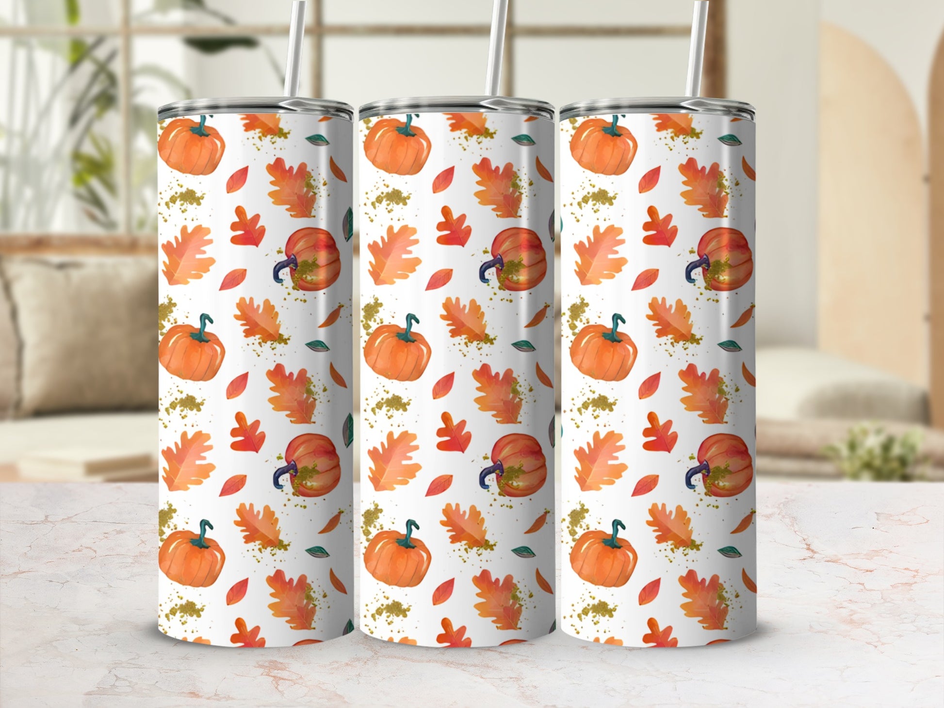 Three tumblers with a fall leaf and pumpkin pattern.