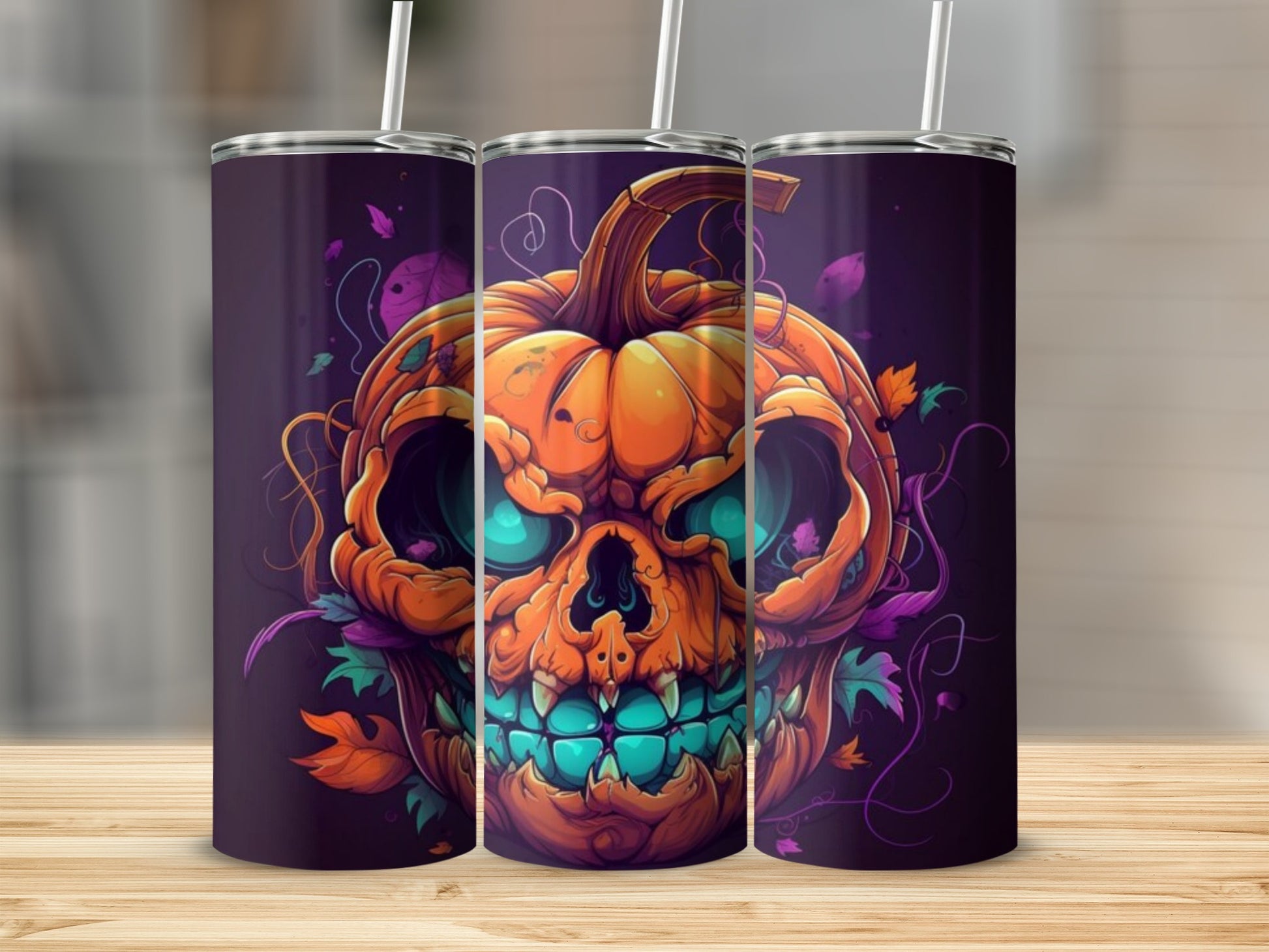 Halloween pumpkin skull design on three tumblers with straws.