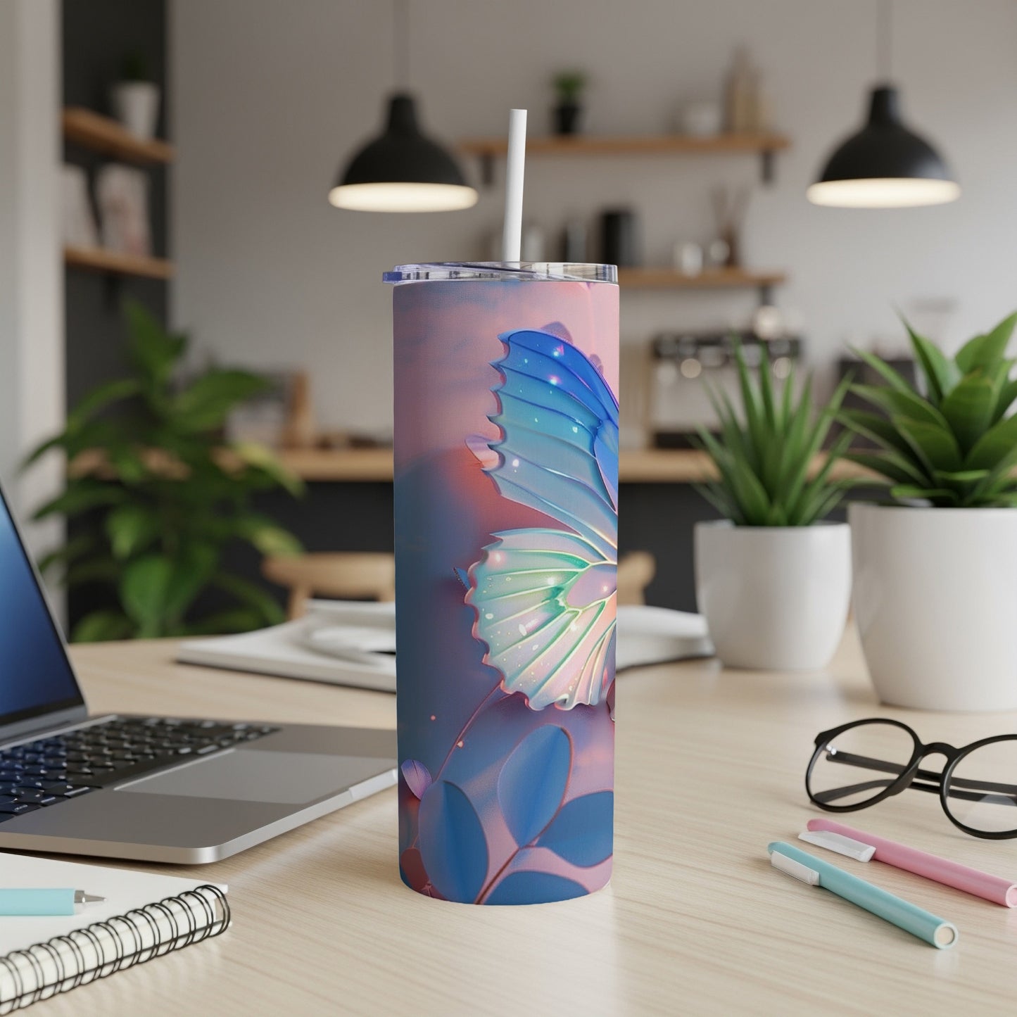 Tumbler with iridescent butterfly and blue leaves design.