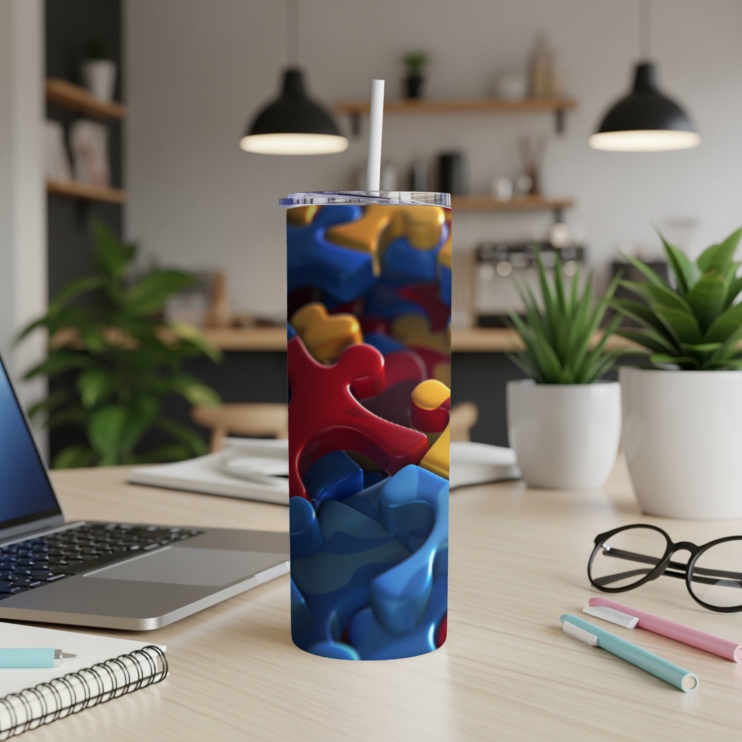 Tumbler with colorful interlocking puzzle pieces and a white straw.