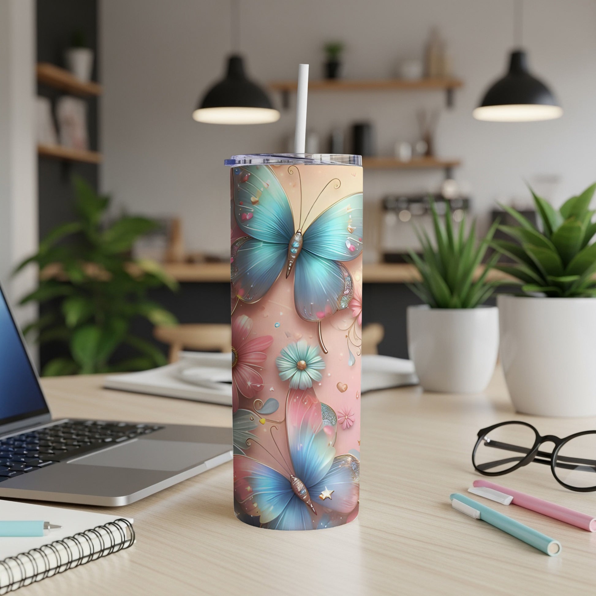 Pink tumbler with blue butterflies and floral accents on a desk.
