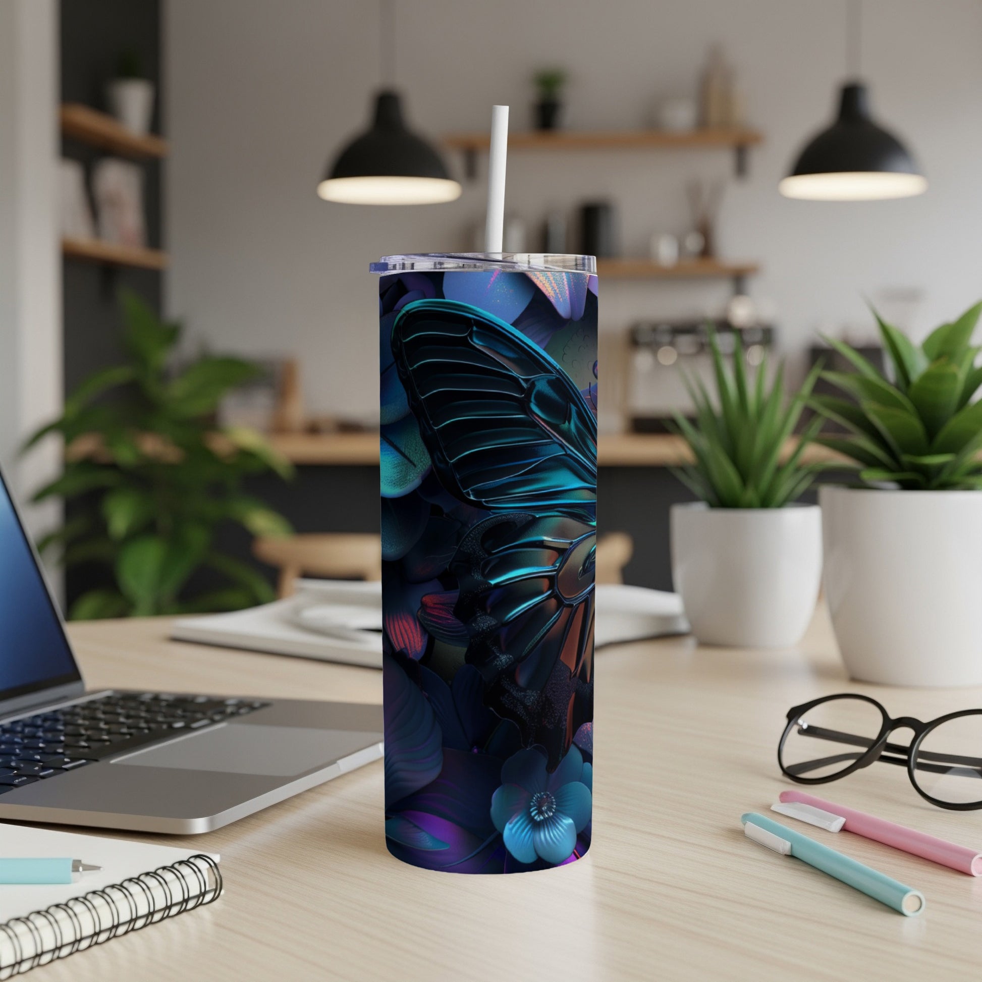 Tumbler with iridescent butterfly and floral design on a desk.