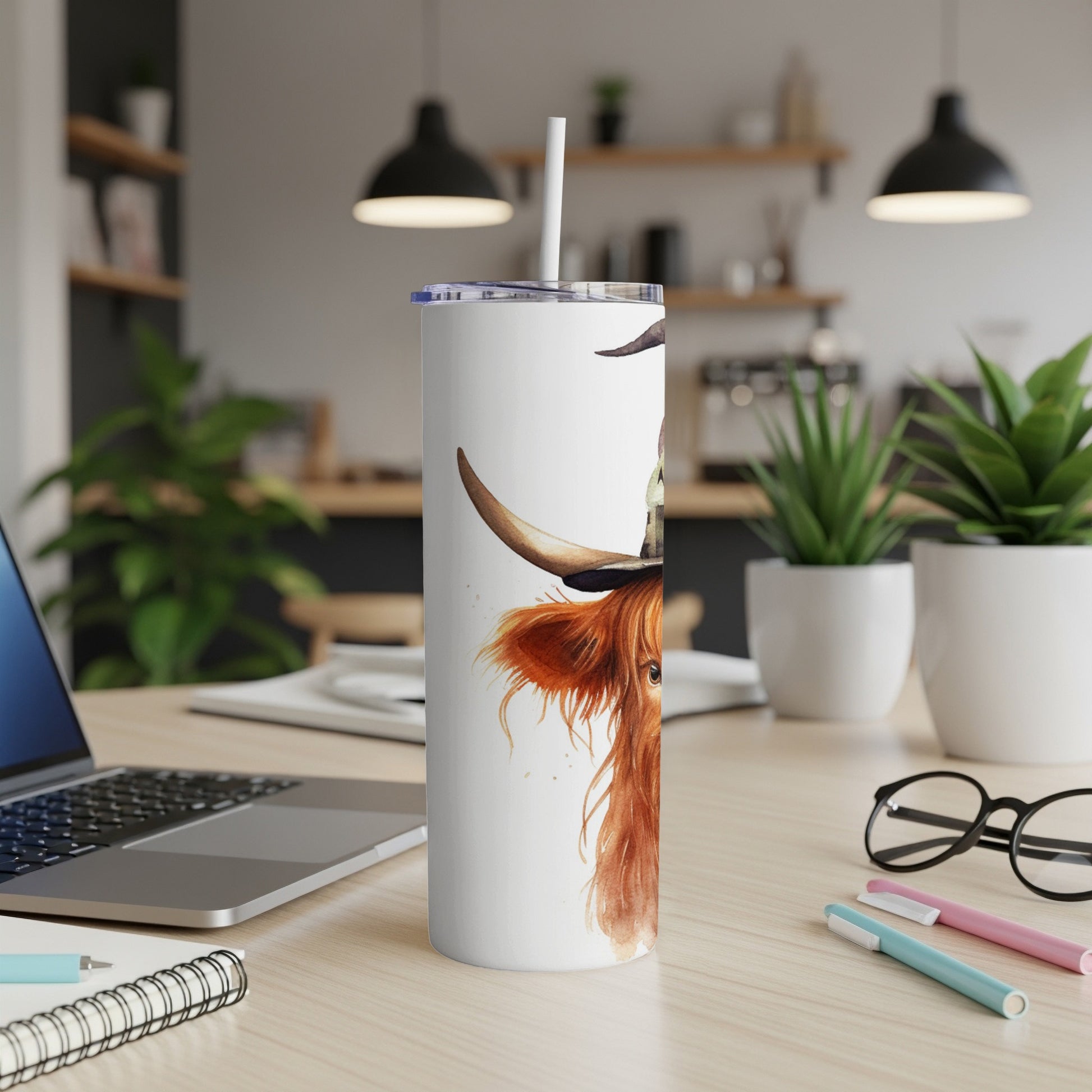 White tumbler with watercolor highland cow wearing a hat.