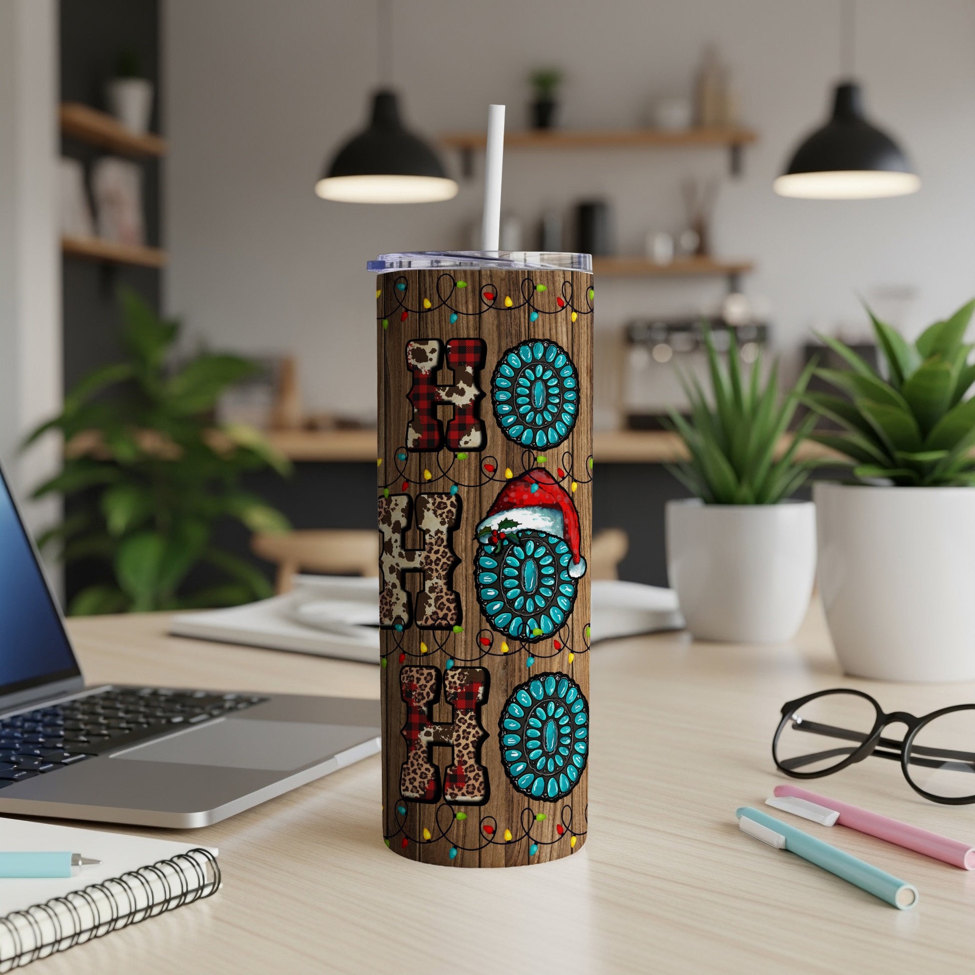 Christmas tumbler with "HO HO HO" and Santa hat on wood grain background.