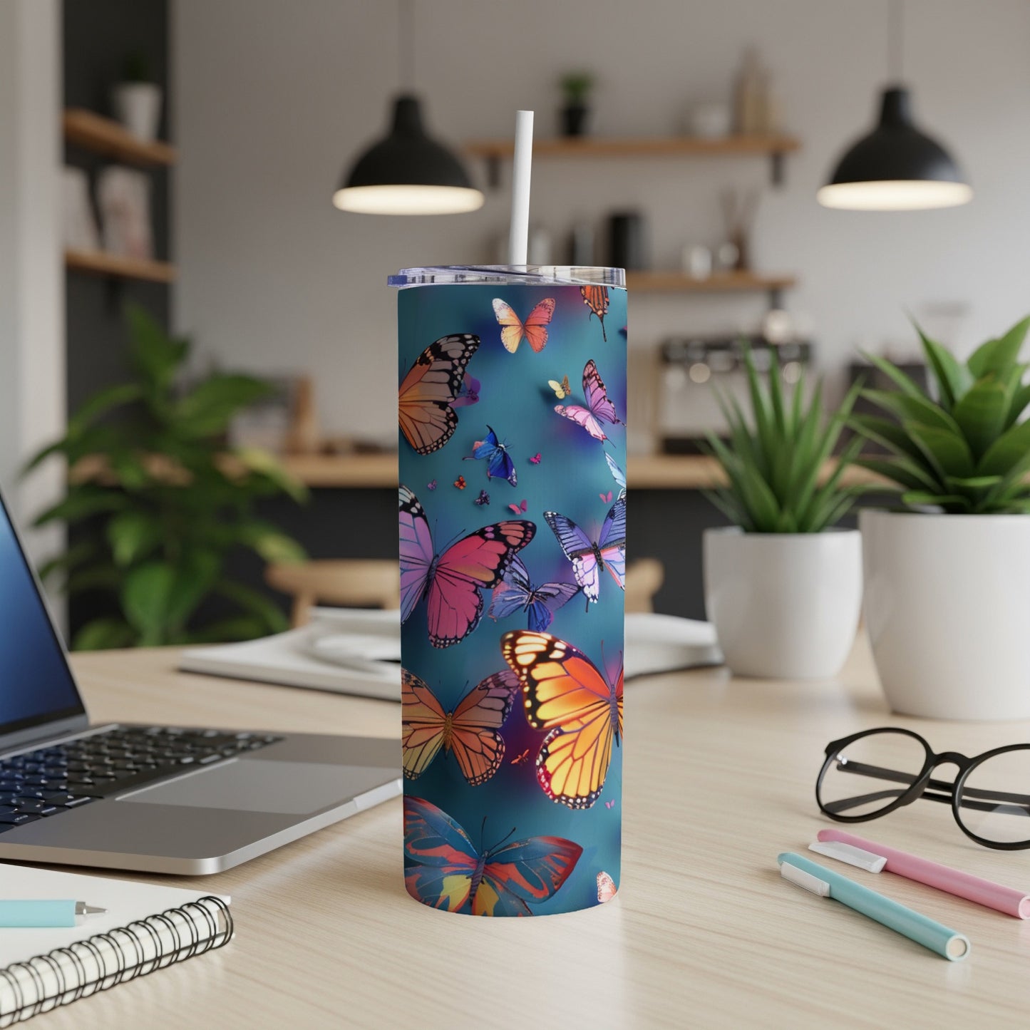 Tall tumbler with vibrant butterflies on a teal background.