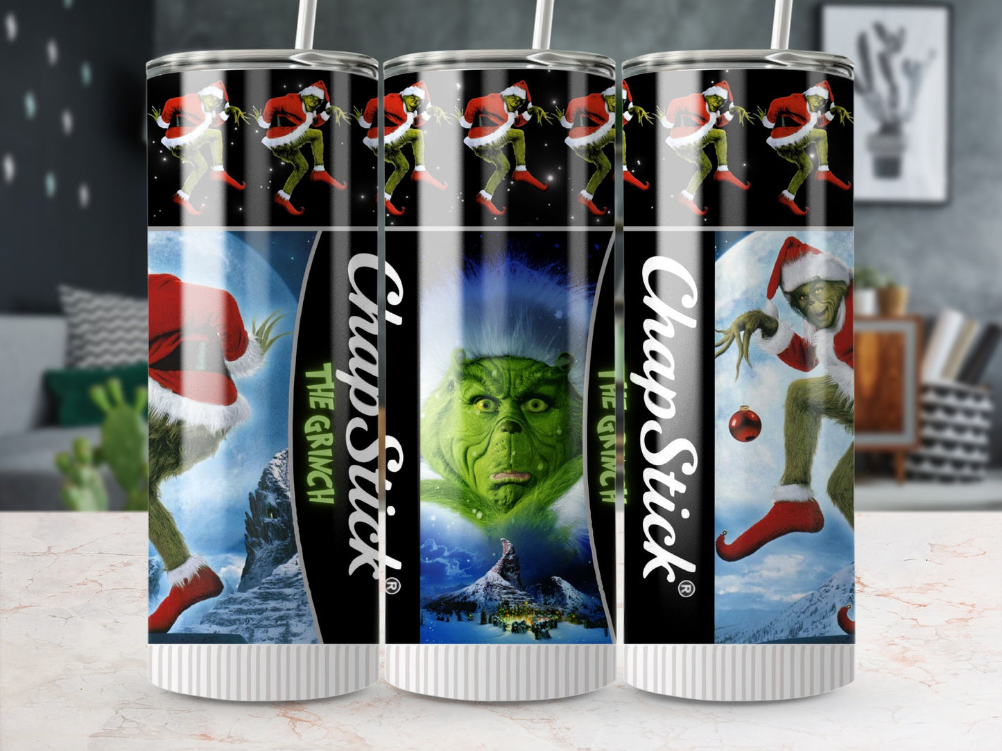 ChapStick tumbler with the Grinch, Santa hats, and snow-covered mountains.