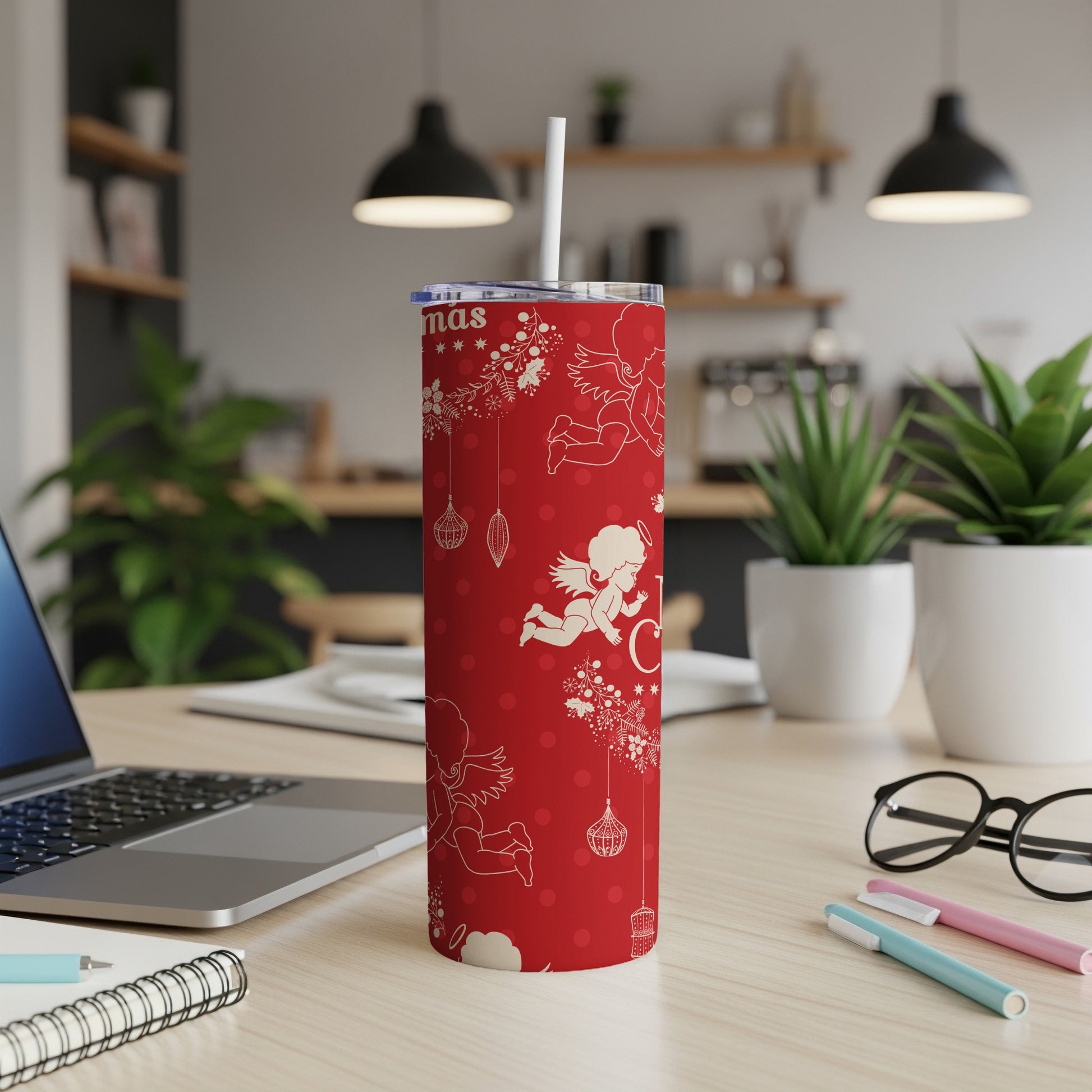 Red Christmas tumbler with white angels and ornaments.