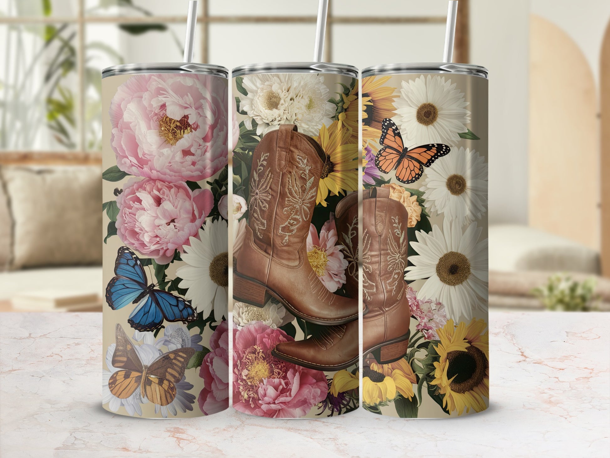 Floral cowboy boots with butterflies and sunflowers on a marble surface.