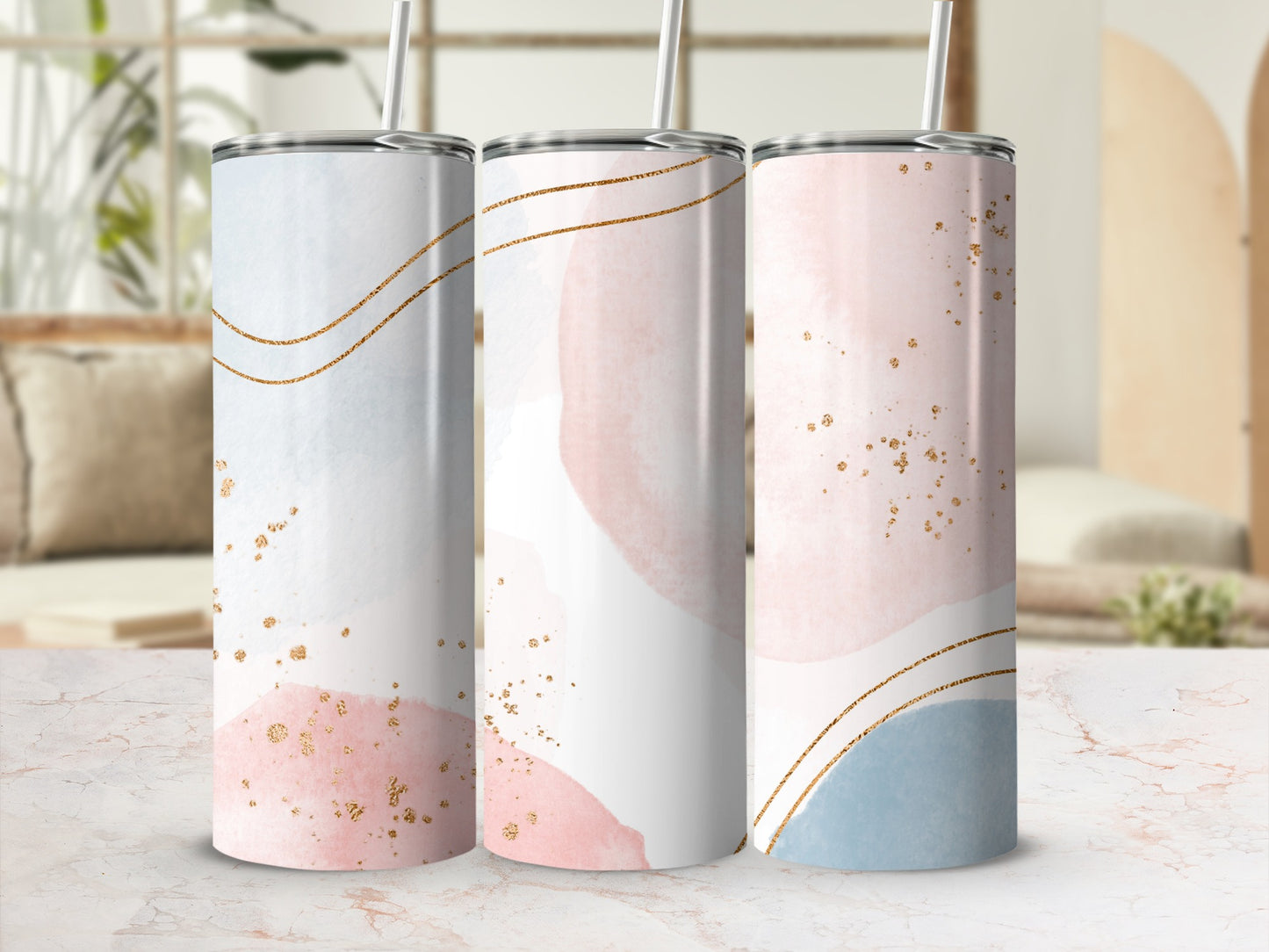 Three pastel-colored tumblers with gold accents and watercolor brush strokes.