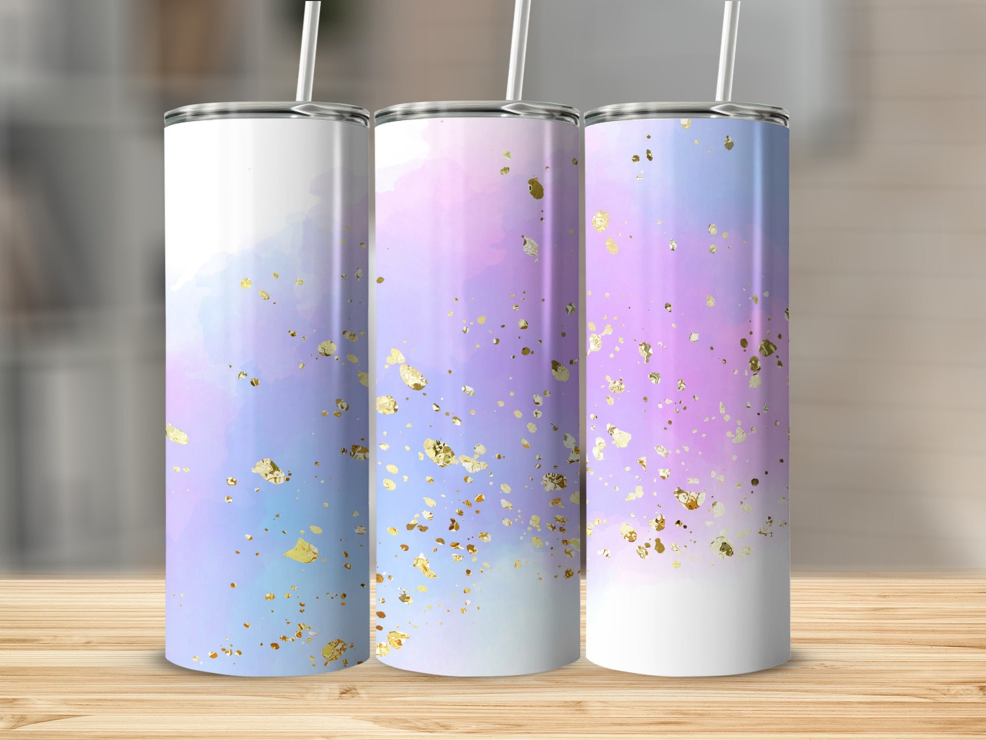 Three tumblers with a watercolor purple and pink design and gold flecks.