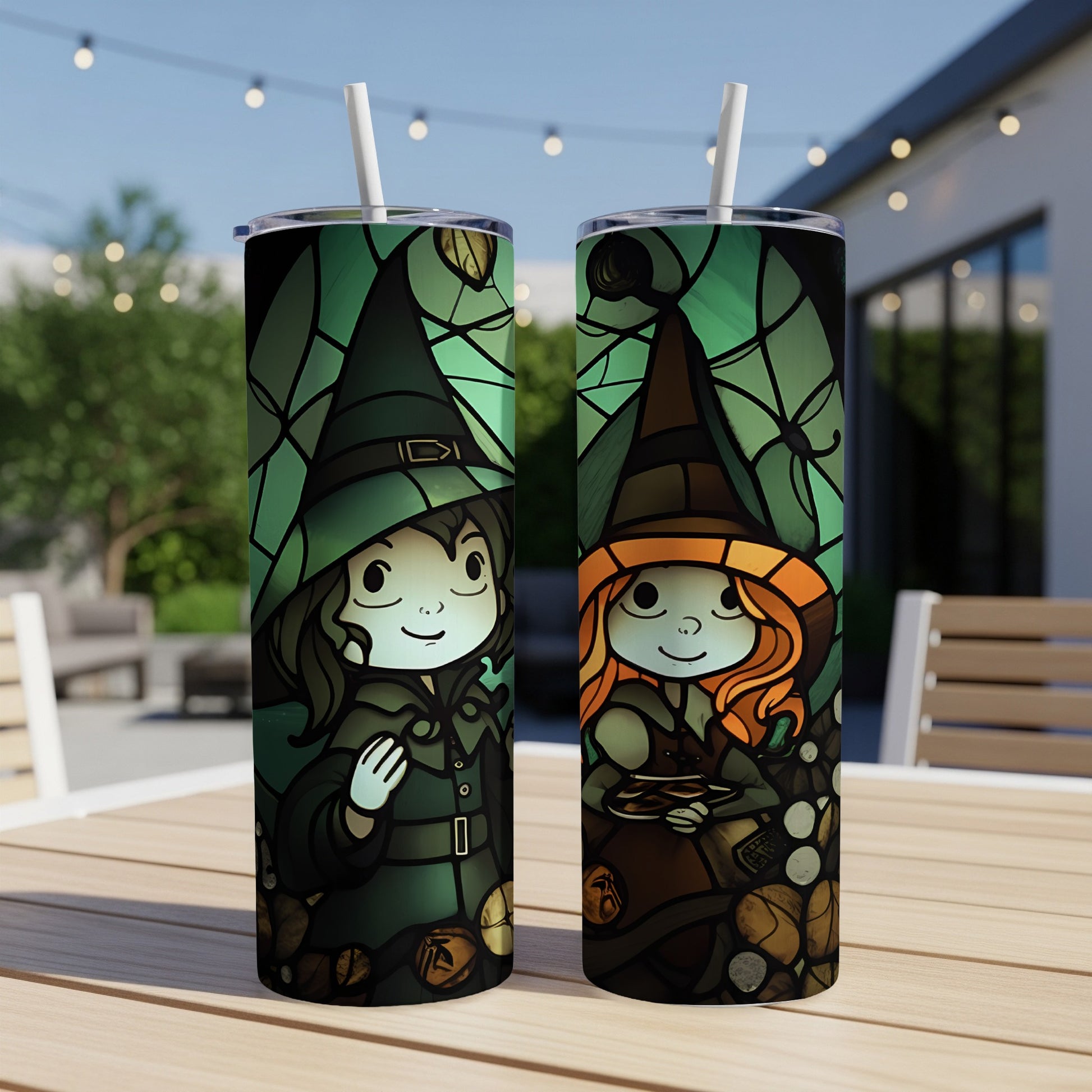 Two tumblers with witch illustrations on an outdoor table.