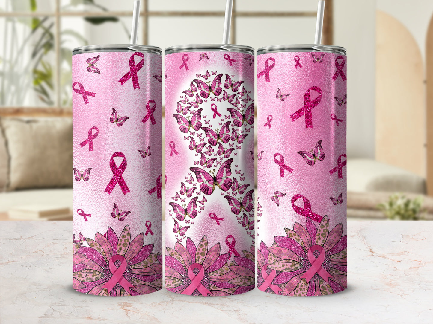 Pink ribbon and butterfly pattern on three tumblers with straws.
