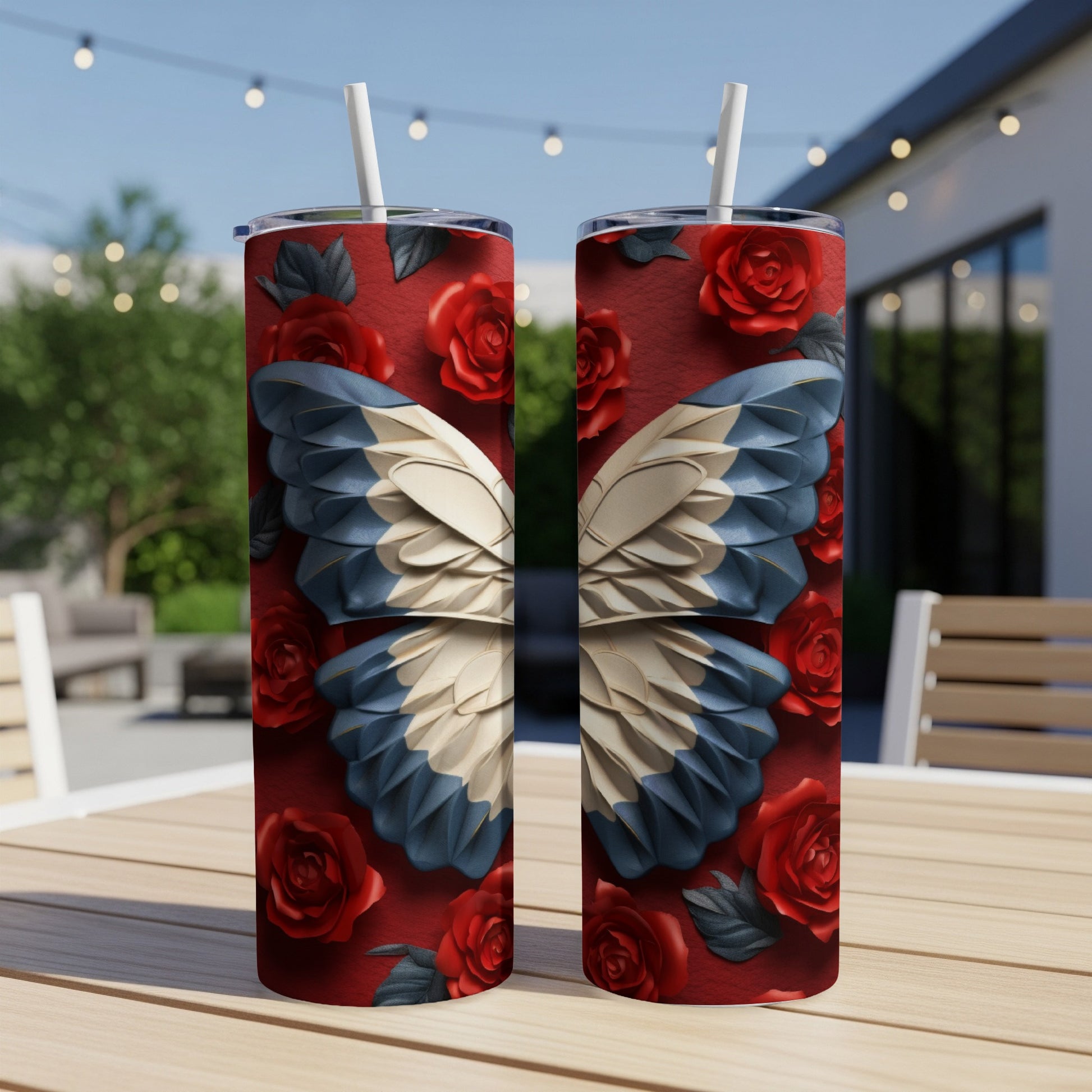 Two tumblers with a butterfly wing and rose design, on a table.