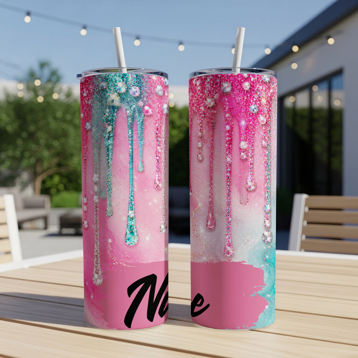 Two pink and teal glitter tumblers with jewel drips and the word "Name"