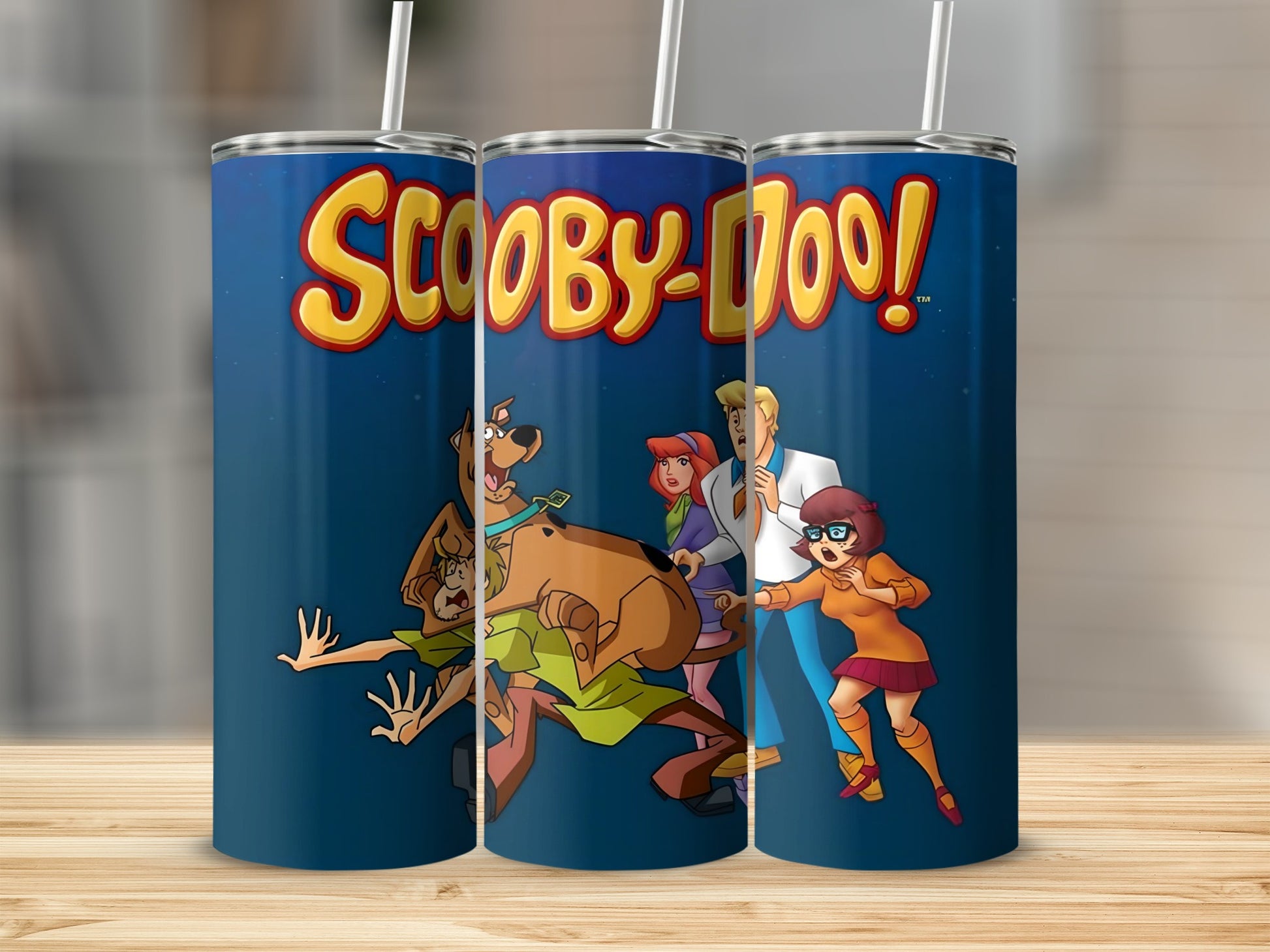 Scooby-Doo characters Fred, Daphne, Velma, and Shaggy on a blue background.