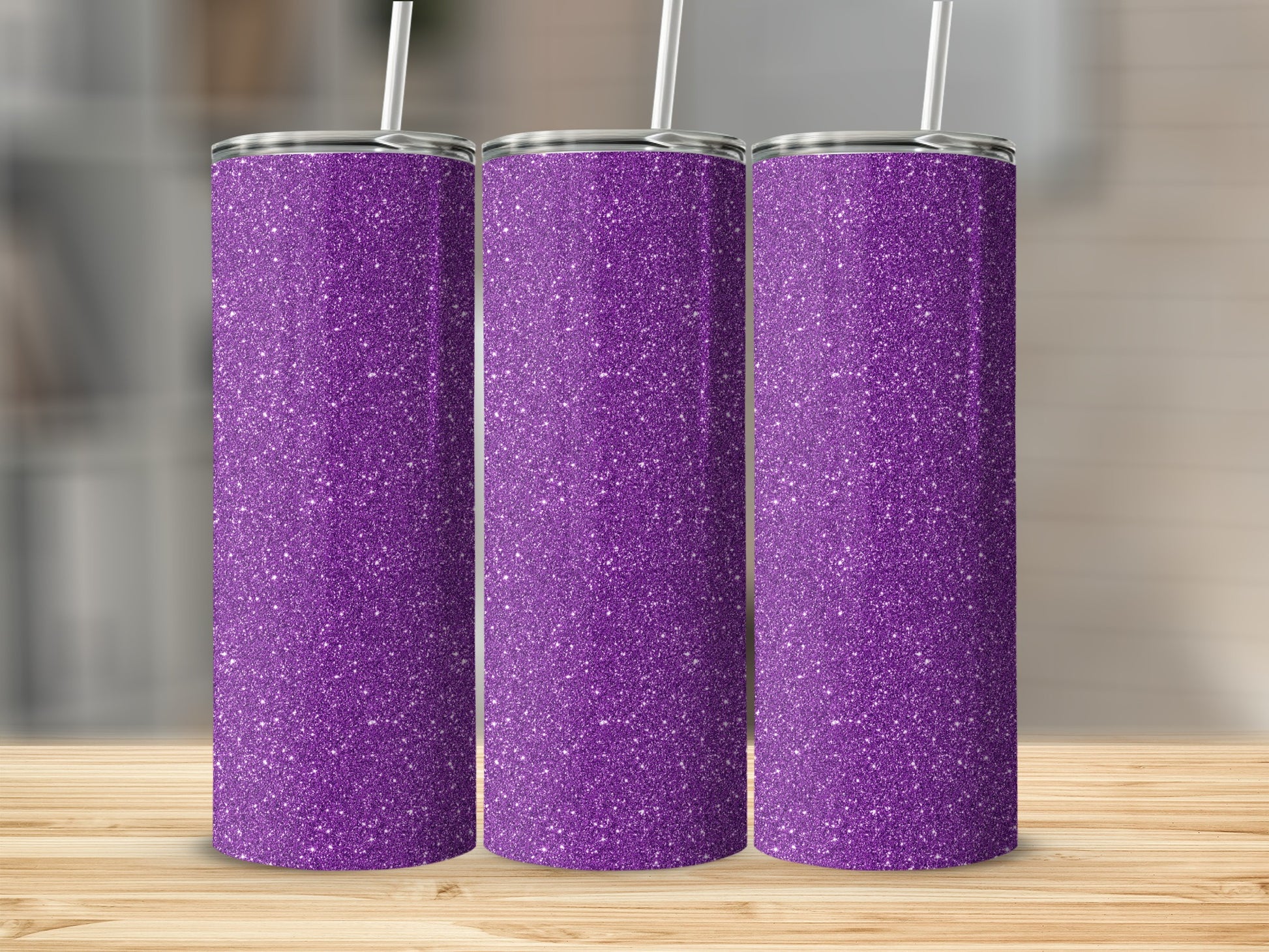 Three purple glitter tumblers with white straws stand on a wooden surface.
