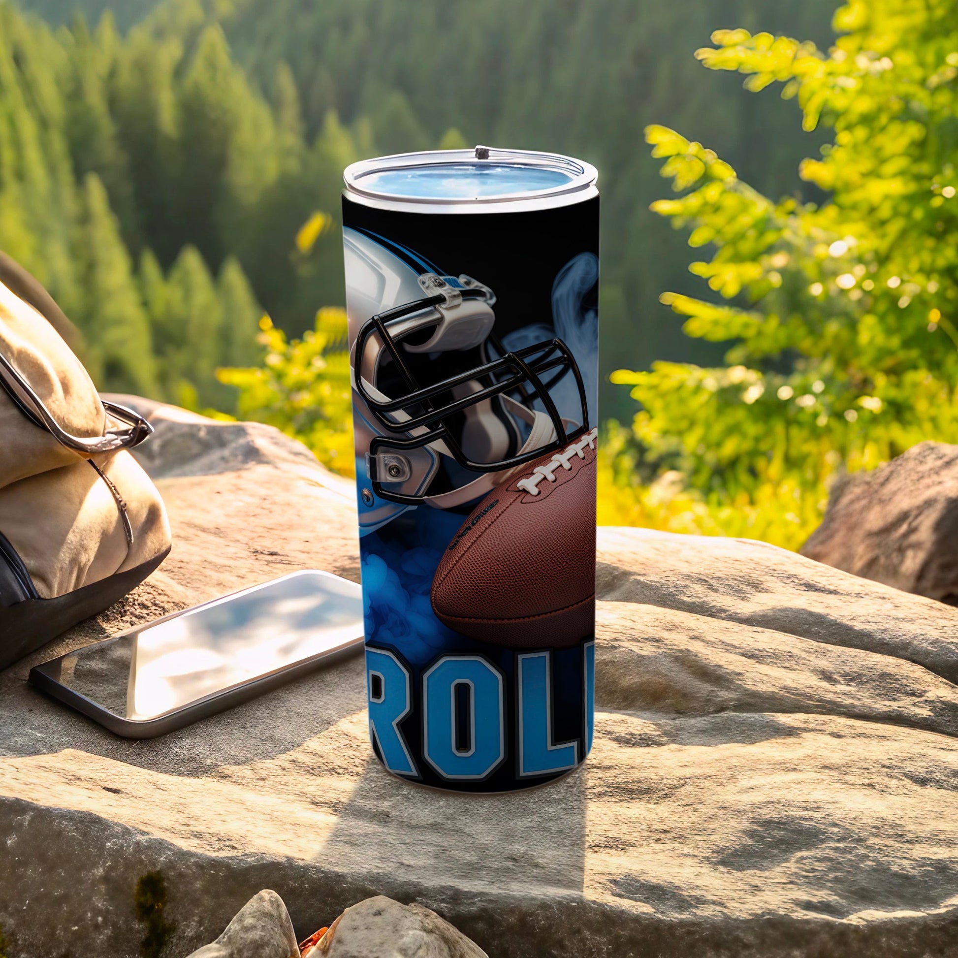 Carolina Panthers football helmet and ball on a tumbler with rocky background.