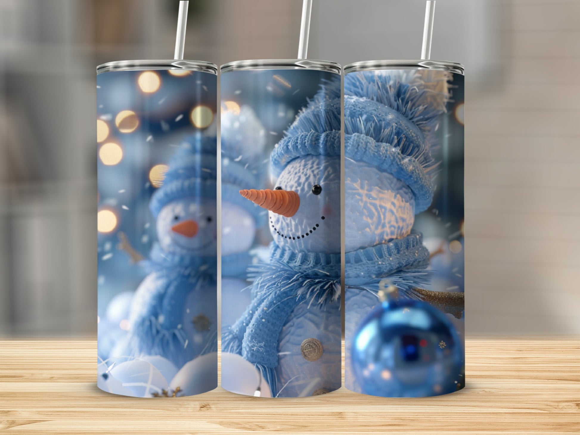 Three tumblers featuring a snowman wearing a blue hat and scarf with orange nose.