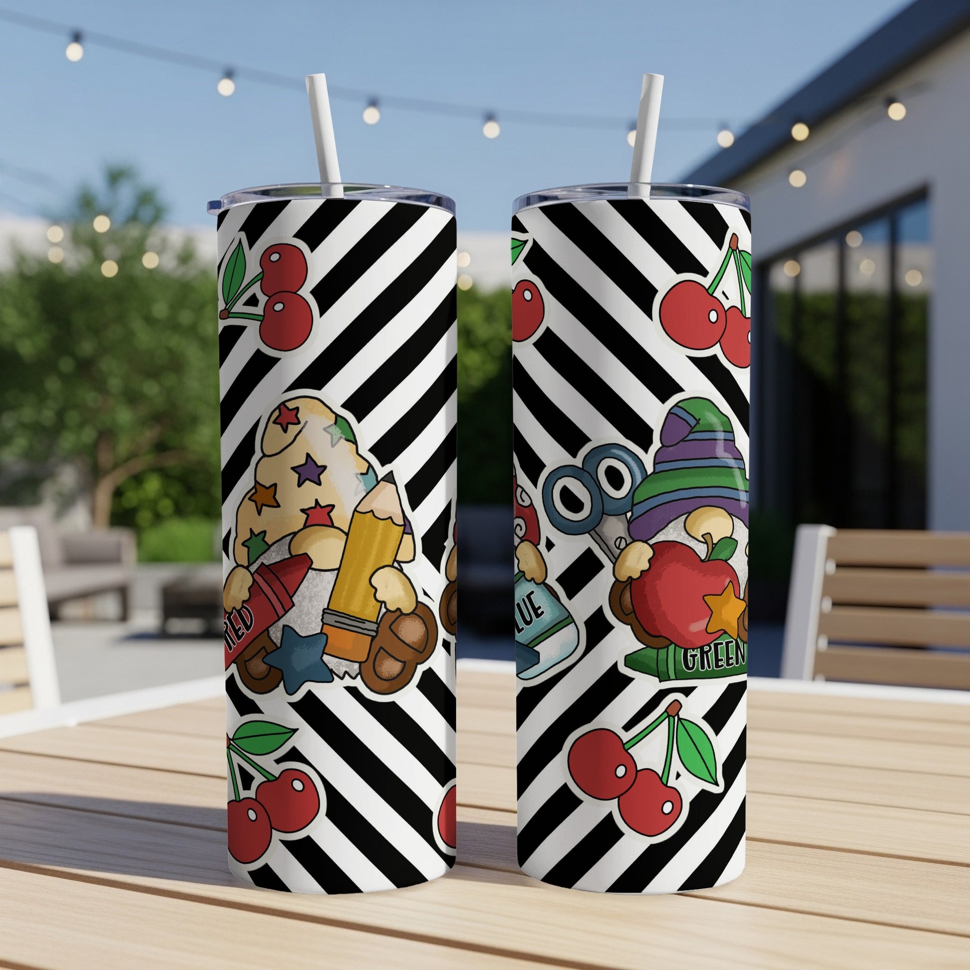 Two tumblers with black and white stripes and cartoon school supplies graphics.