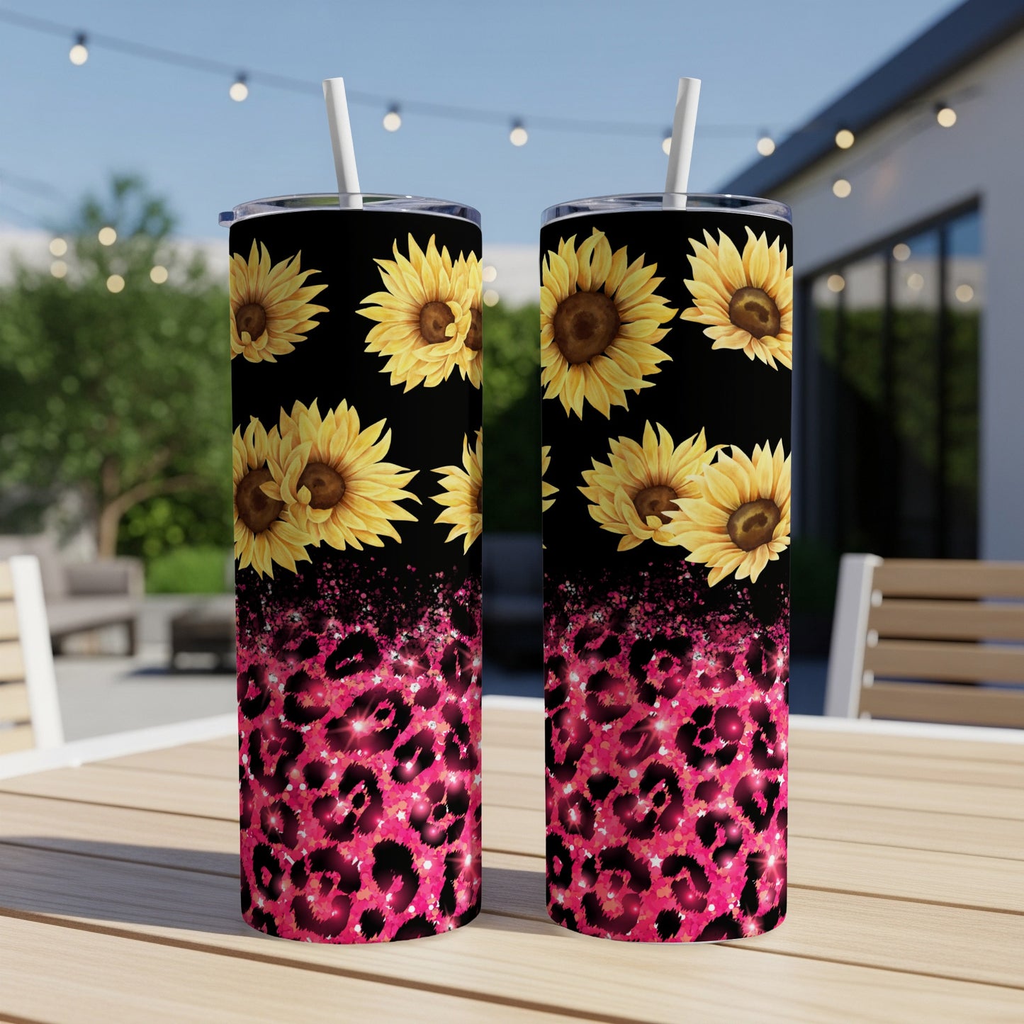Two tumblers with sunflowers and pink leopard print on a table.