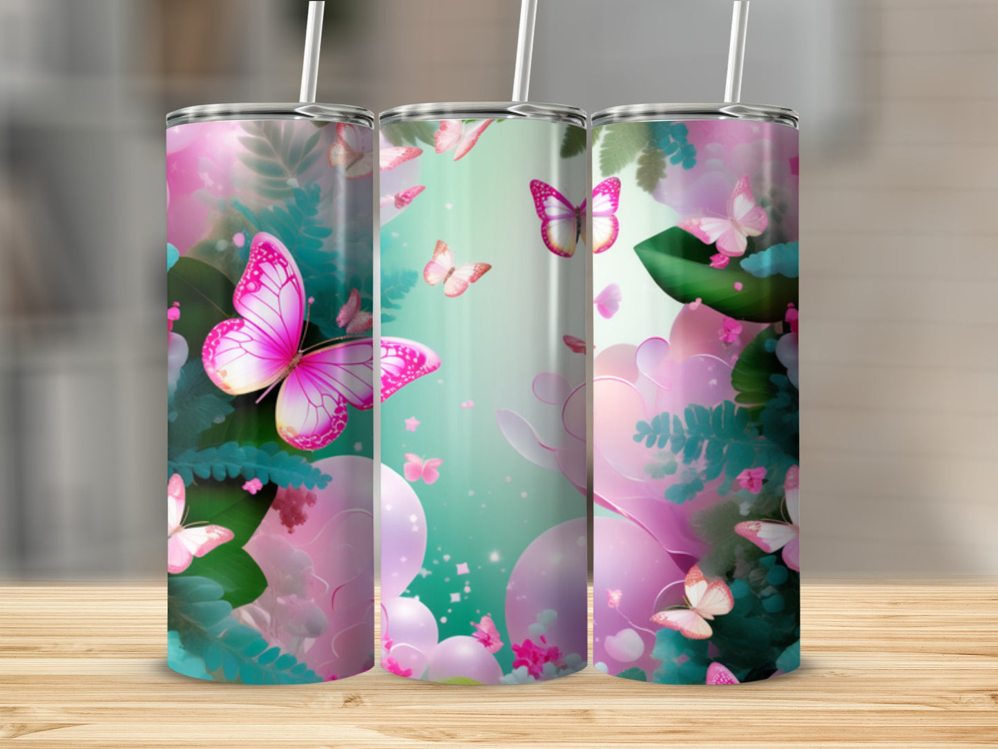 Pink butterflies and lush green foliage adorn three tumblers on a wooden surface.