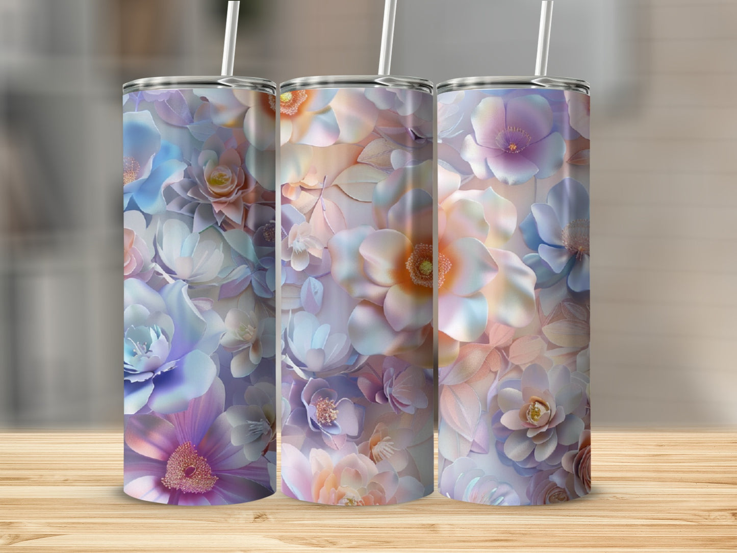 Three tumblers with a pastel floral pattern on a wooden surface.