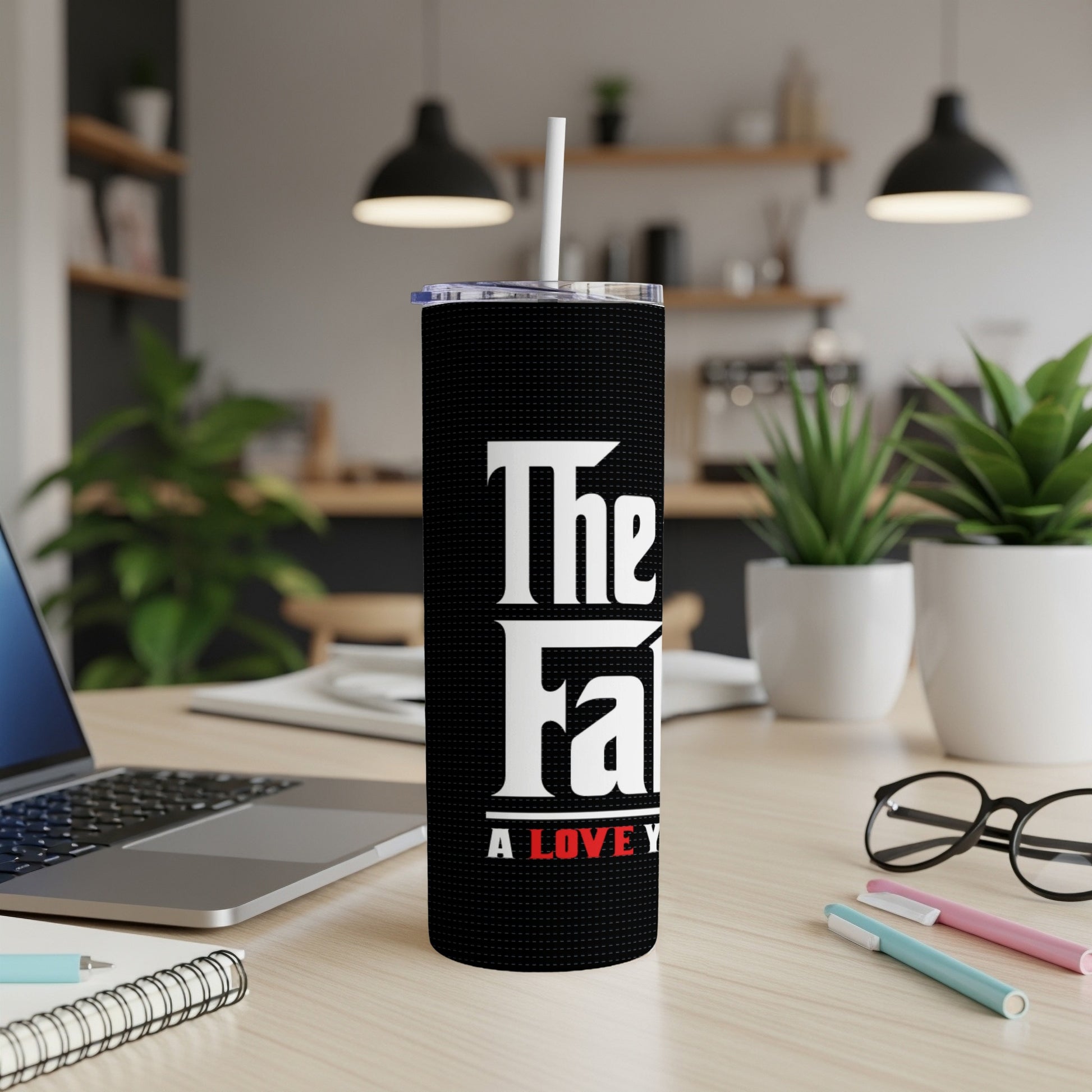 Black tumbler with white text "The Fam" and red text "A Love Y".