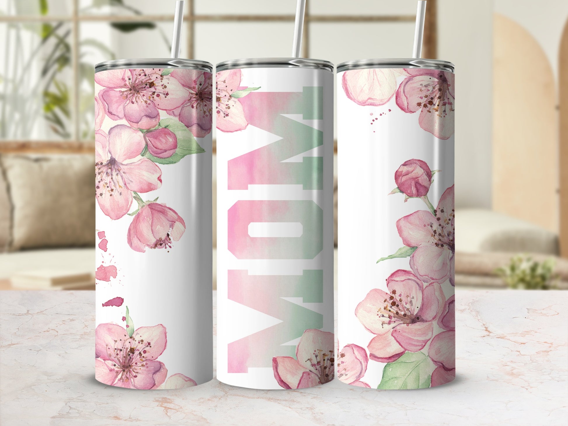 White tumbler with pink floral design and "Mom" text.