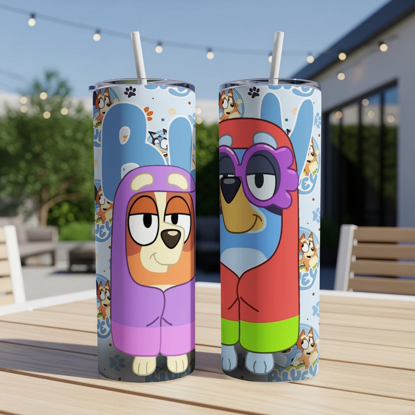 Bluey and Bingo characters on a blue patterned tumbler with straws.